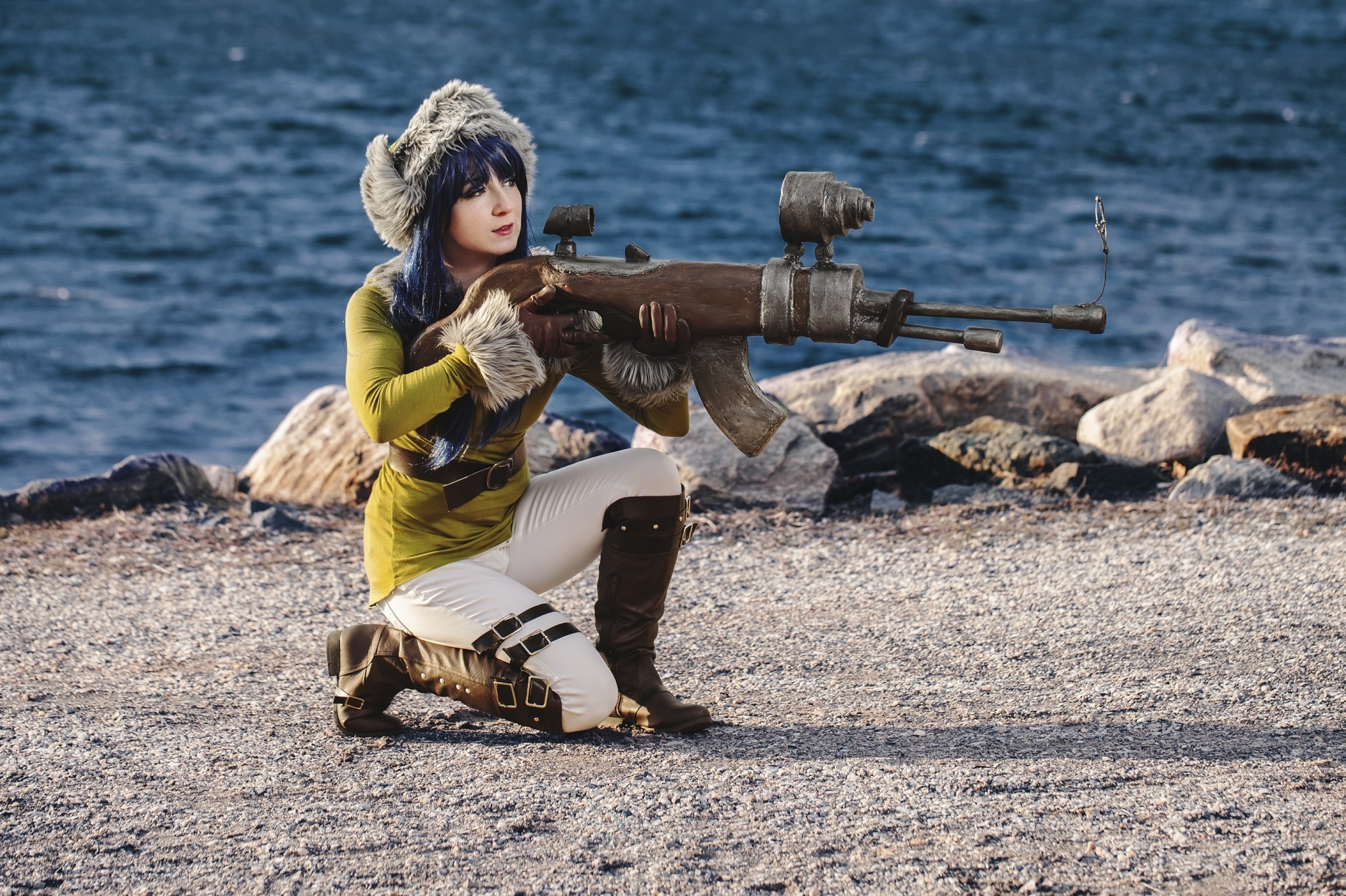 Woman in fur hat with assault rifle on coast HD Wallpaper