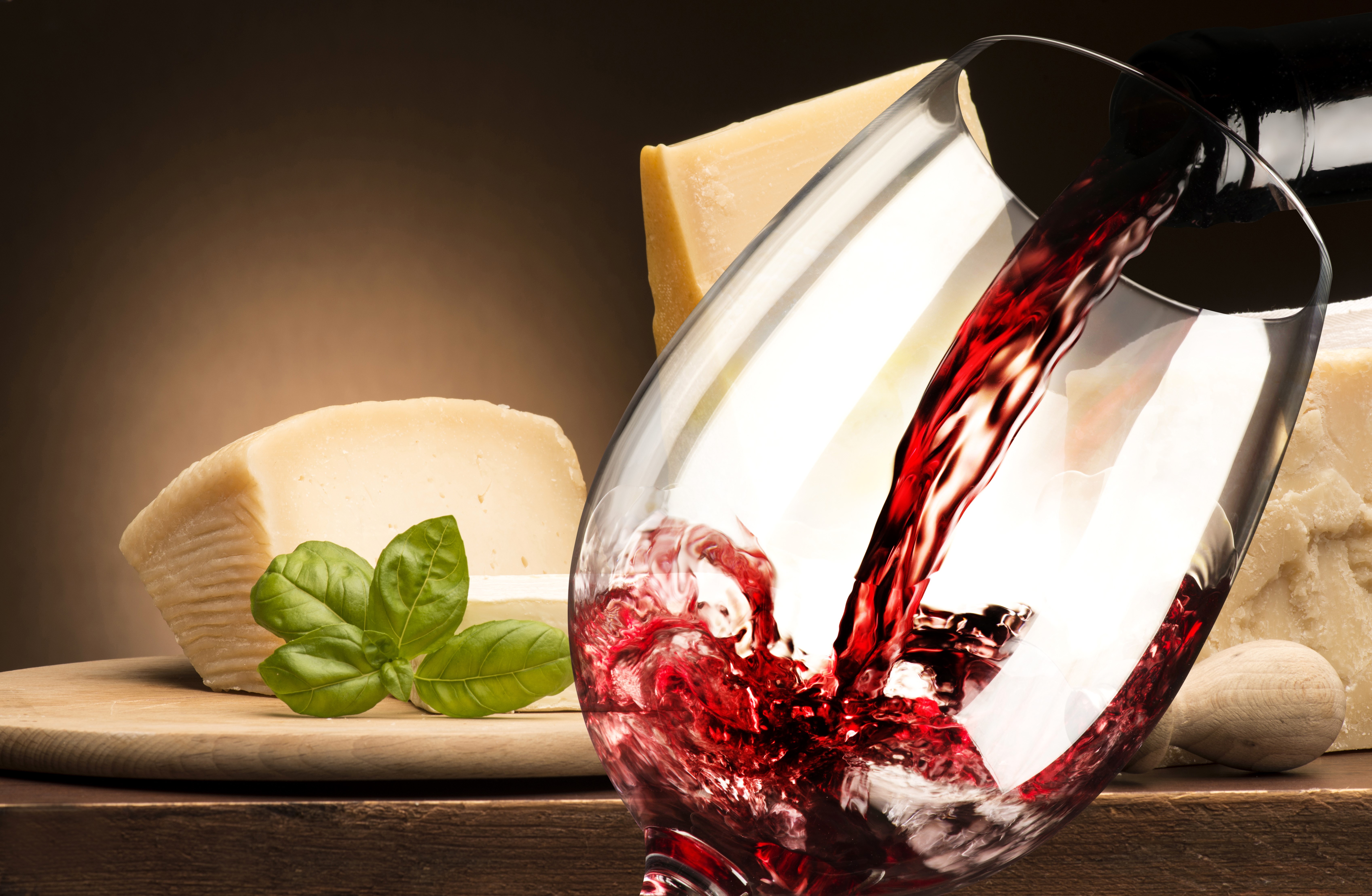 Red wine pouring into a glass with cheese and basil HD Wallpaper