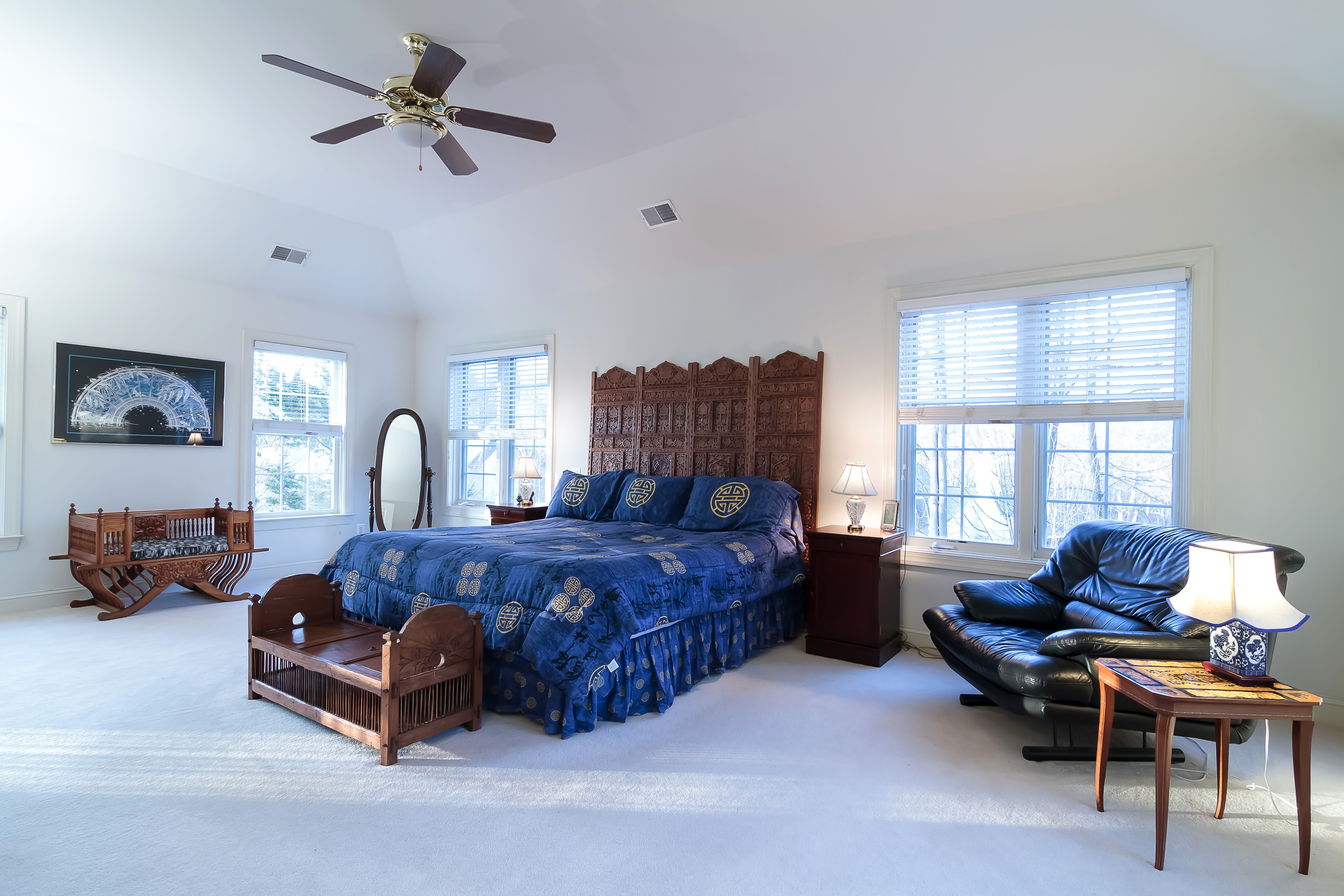 Bedroom with a large bed, armchair, and decorative screen HD Wallpaper