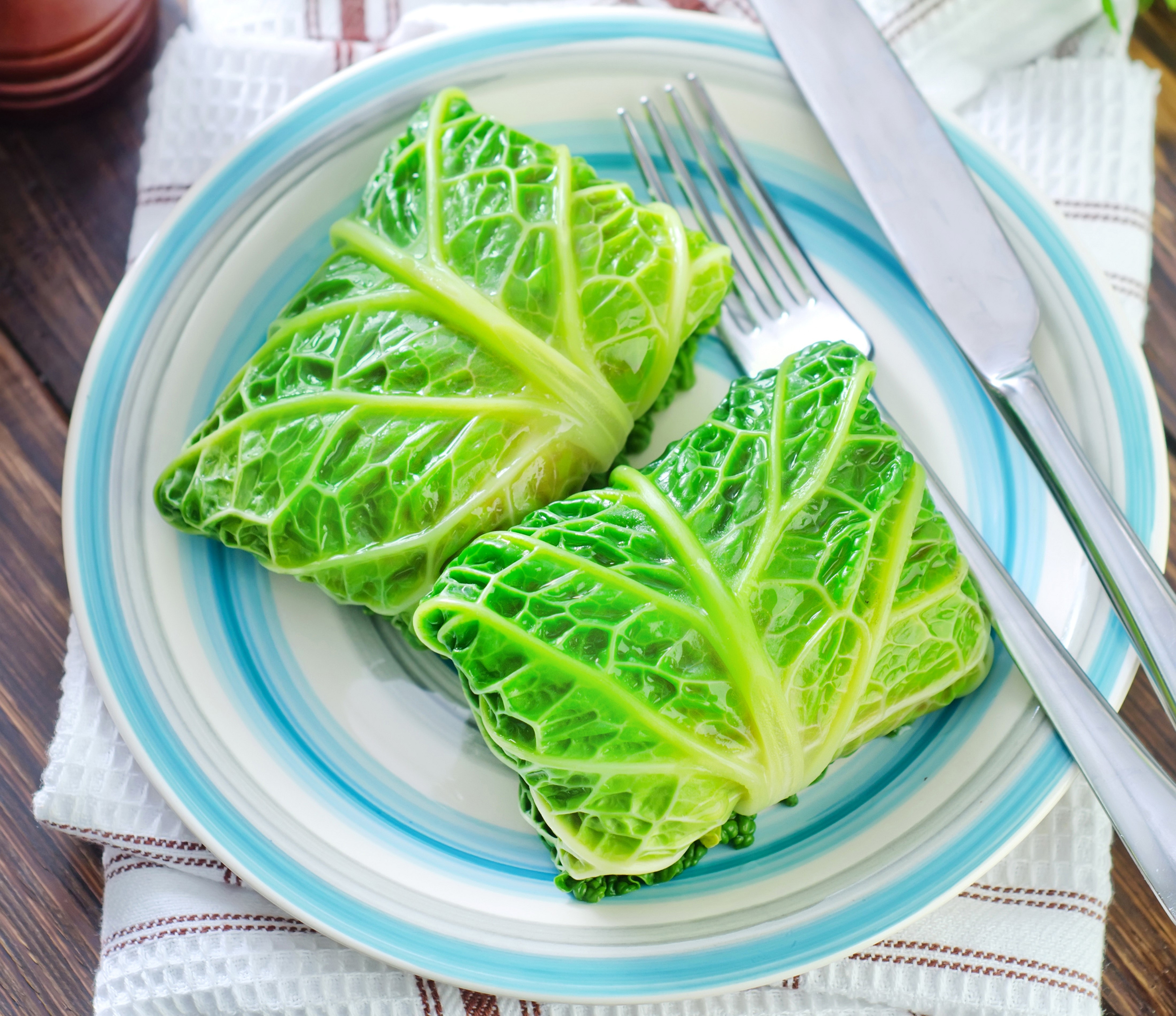 Cabbage rolls on a plate with fork and knife HD Wallpaper