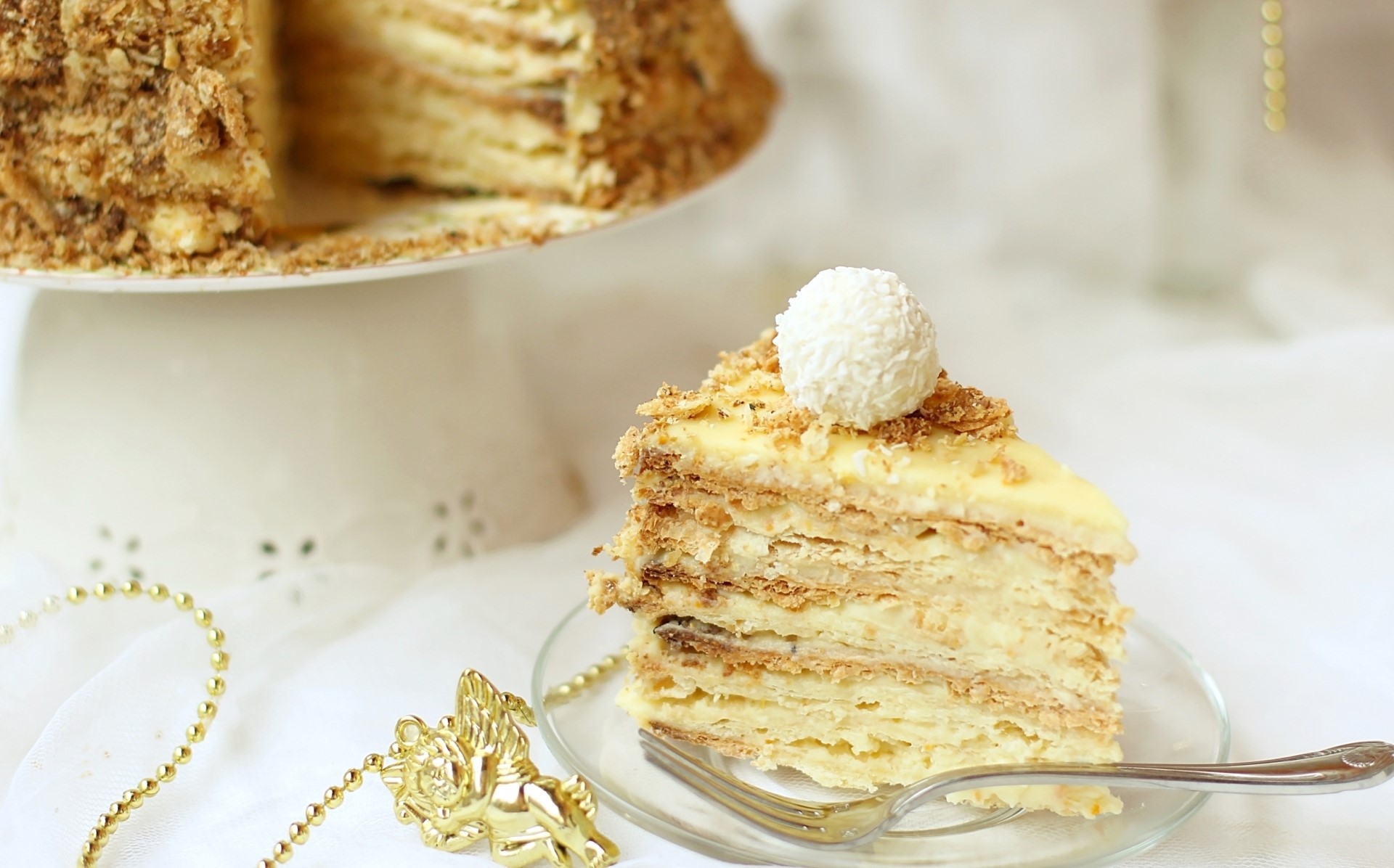 Slice of layered cake with coconut ball on top HD Wallpaper
