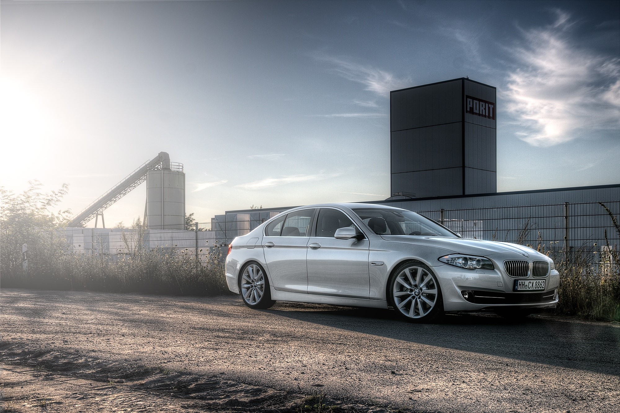 BMW 5 Series F10 520d parked near industrial buildings HD Wallpaper