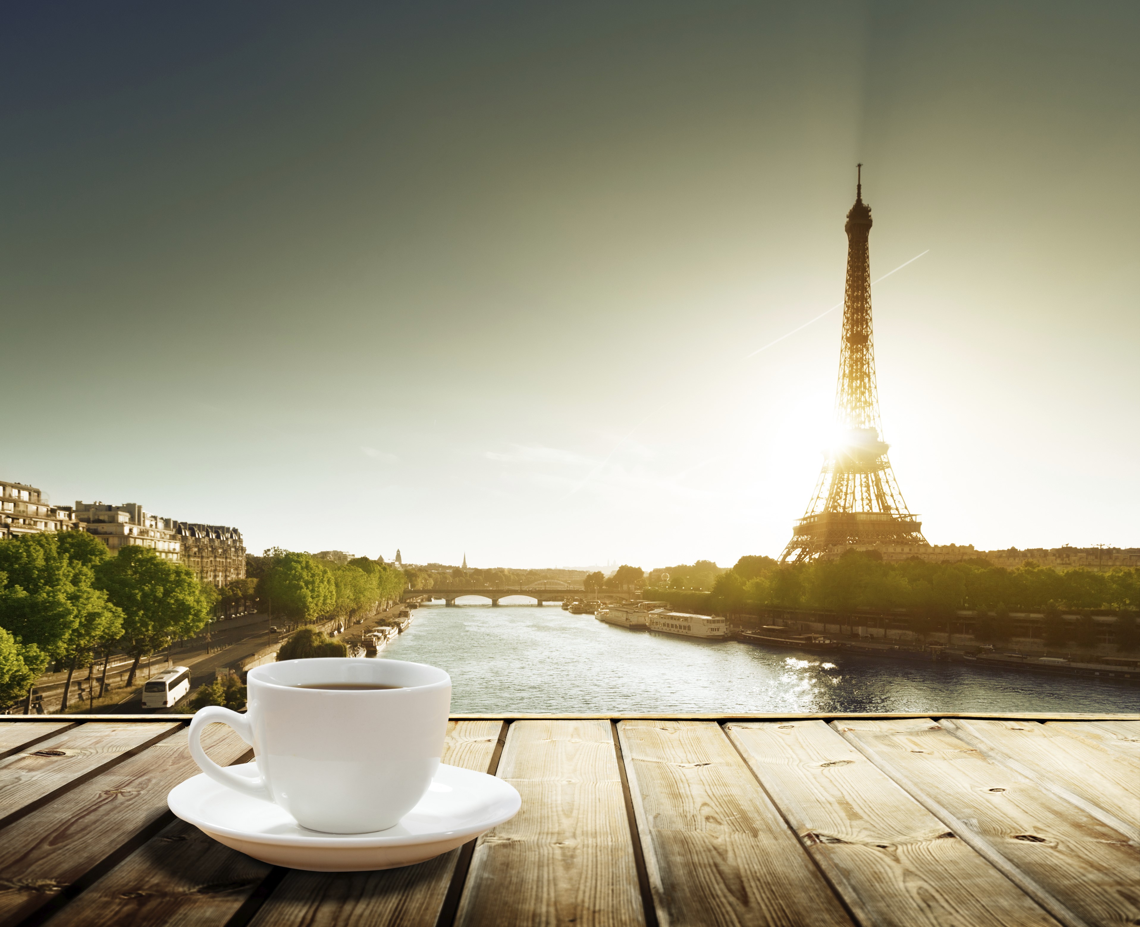 Coffee cup on wooden planks with Eiffel Tower and Seine River in Paris HD Wallpaper