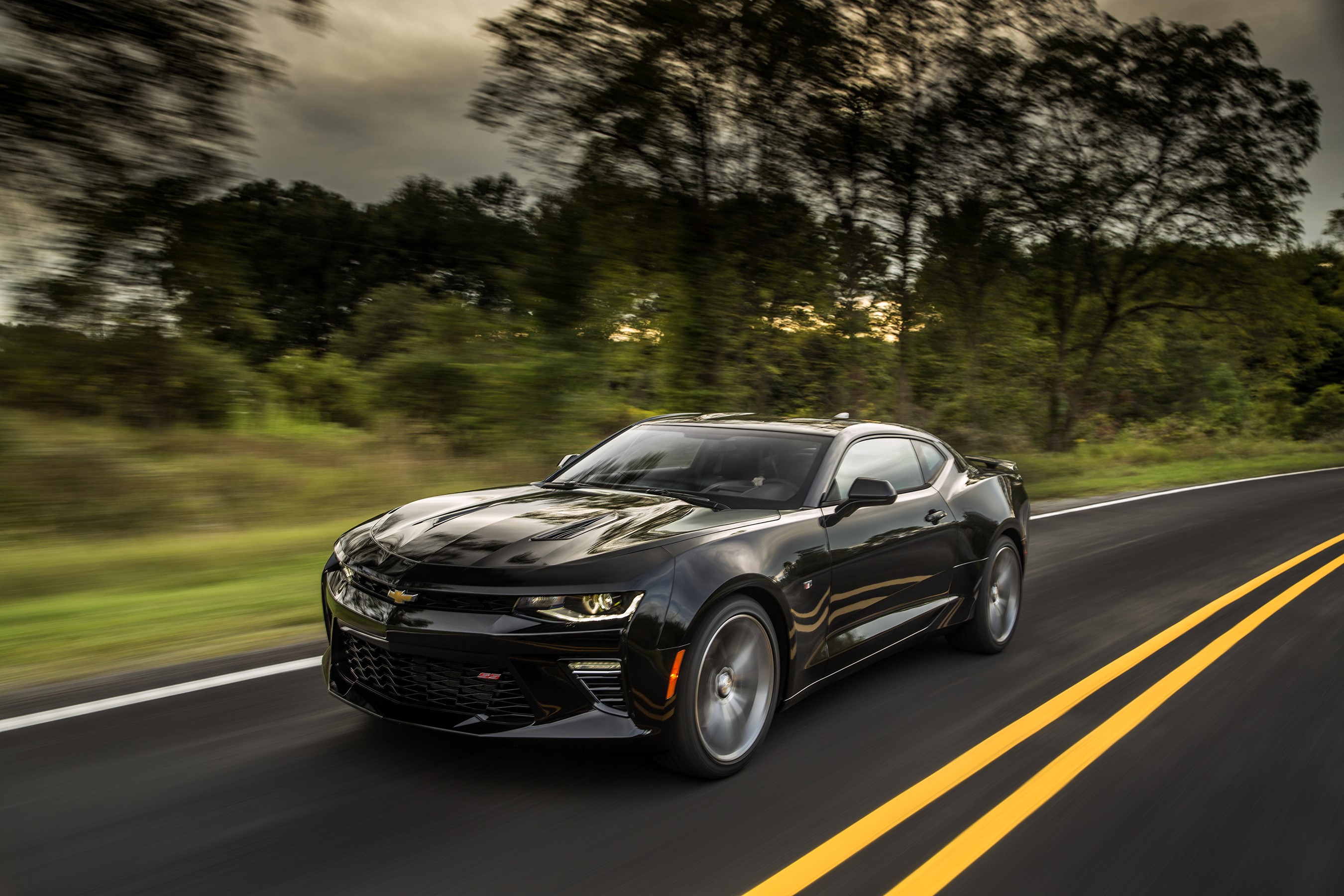 Black 2016 Chevrolet Camaro SS driving on a road HD Wallpaper