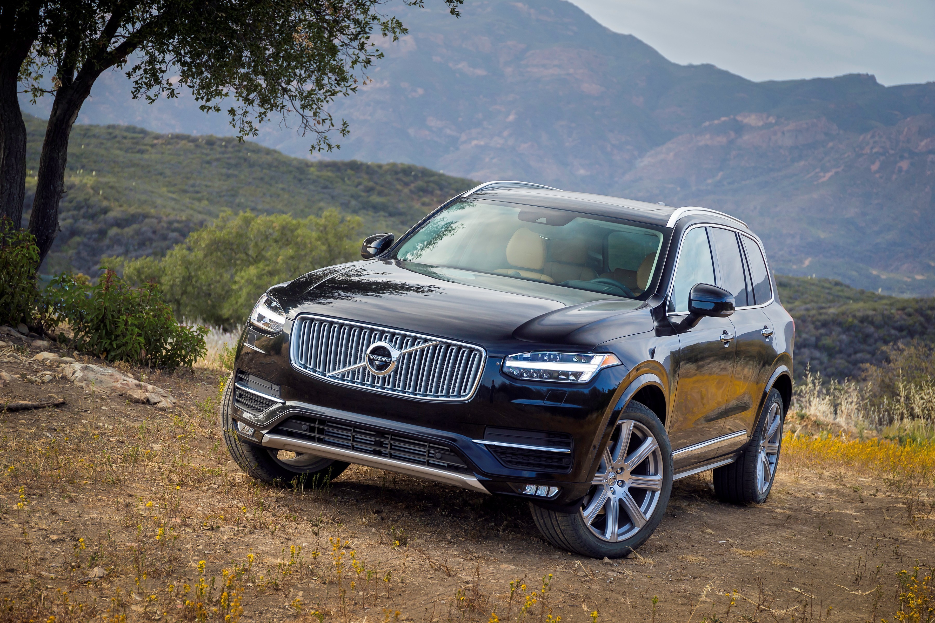 Black Volvo XC90 parked on a dirt road with mountains HD Wallpaper