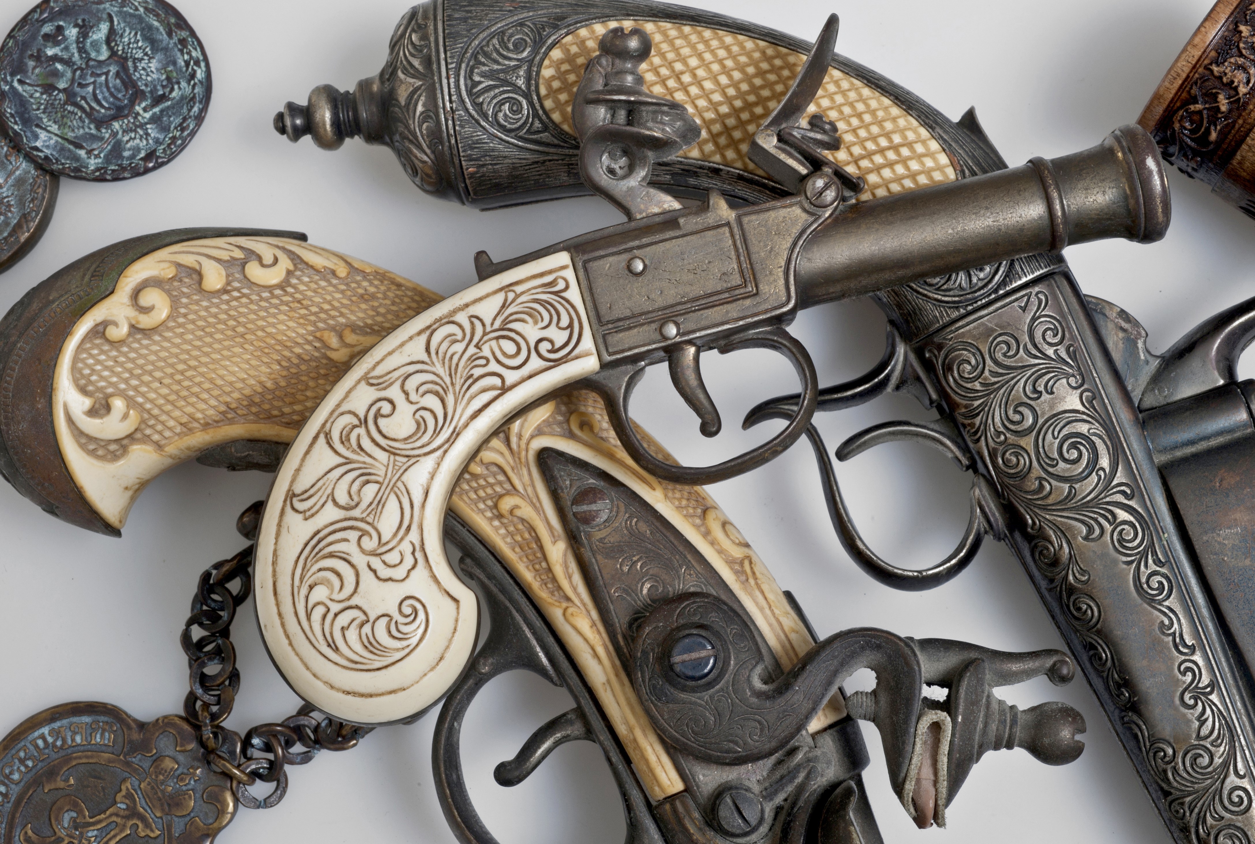 Antique Flintlock Pistols with Ornate Carvings HD Wallpaper