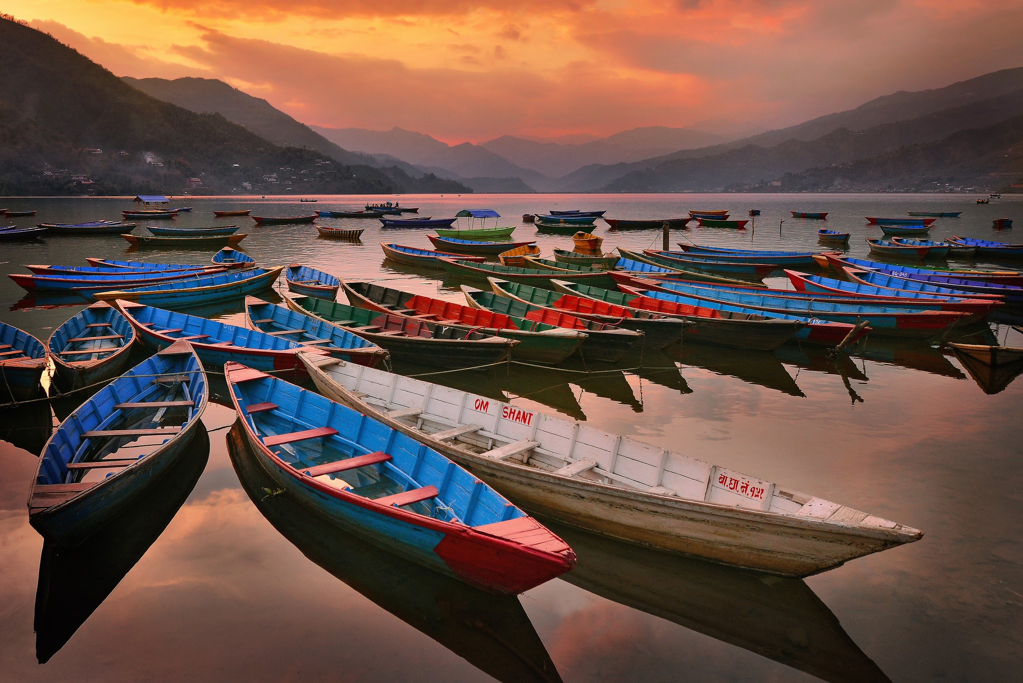 Boats on a lake at sunset with mountains HD Wallpaper