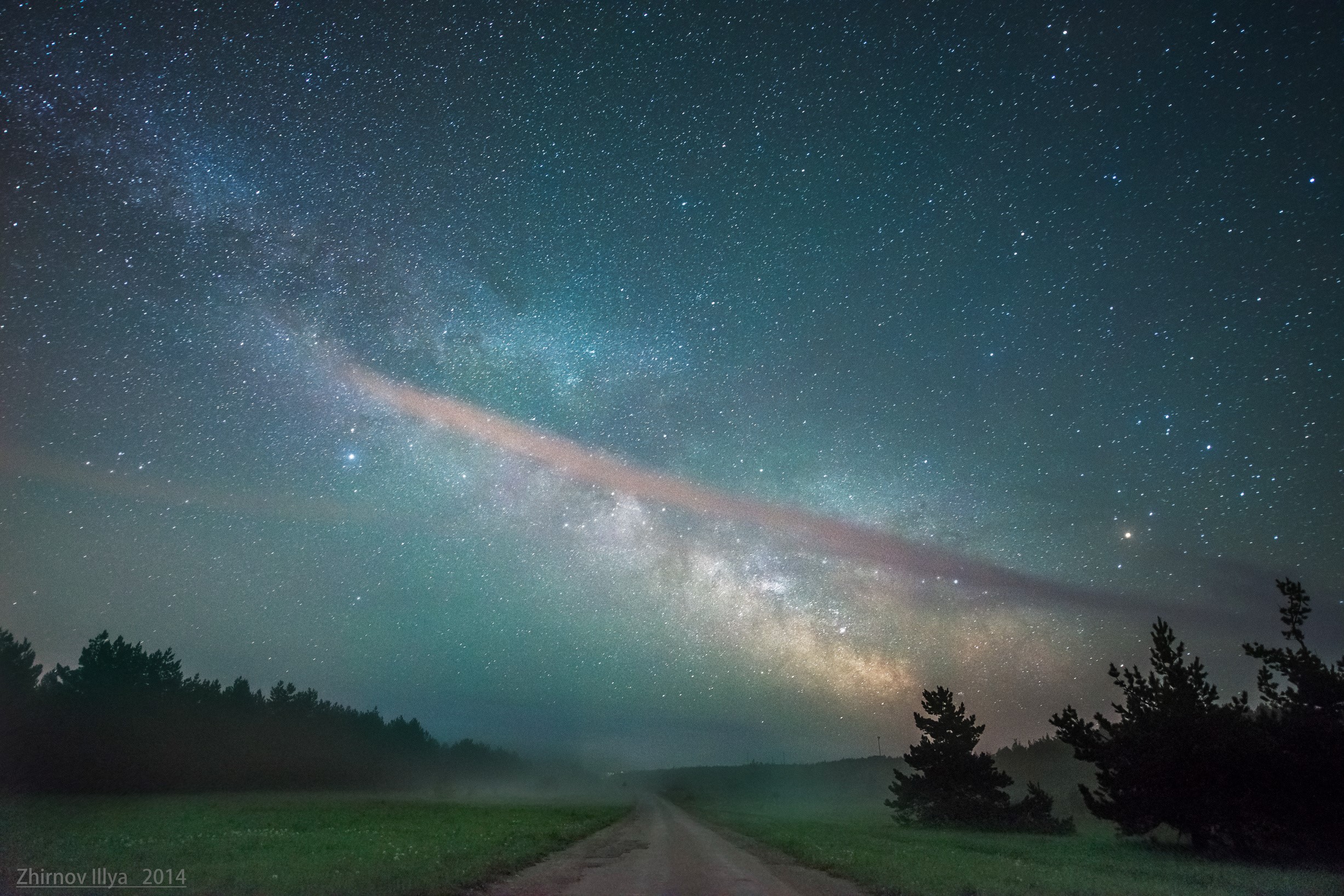 Milky Way over a foggy road and forest at night HD Wallpaper