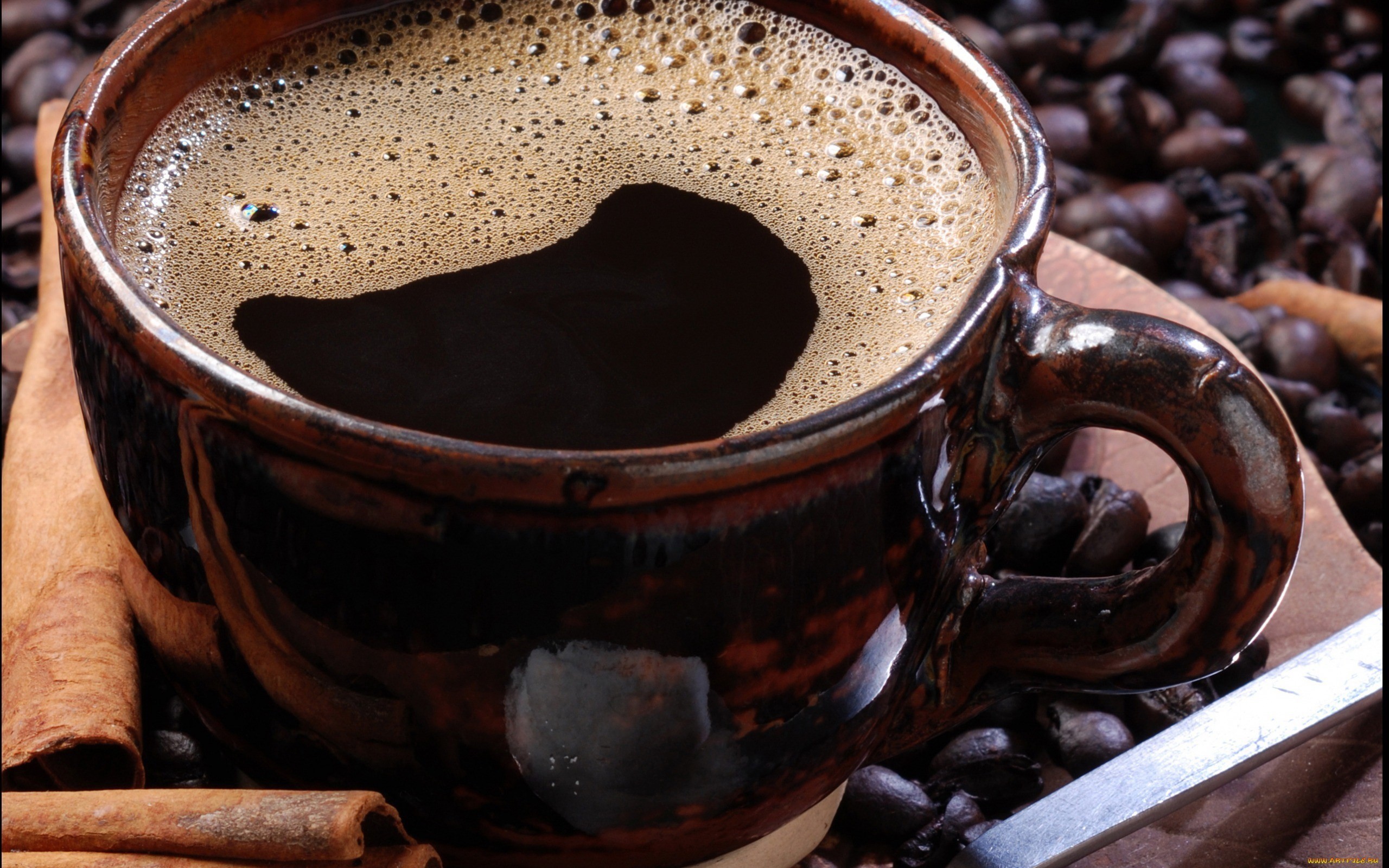 Close-up of a cup of coffee with cinnamon sticks HD Wallpaper