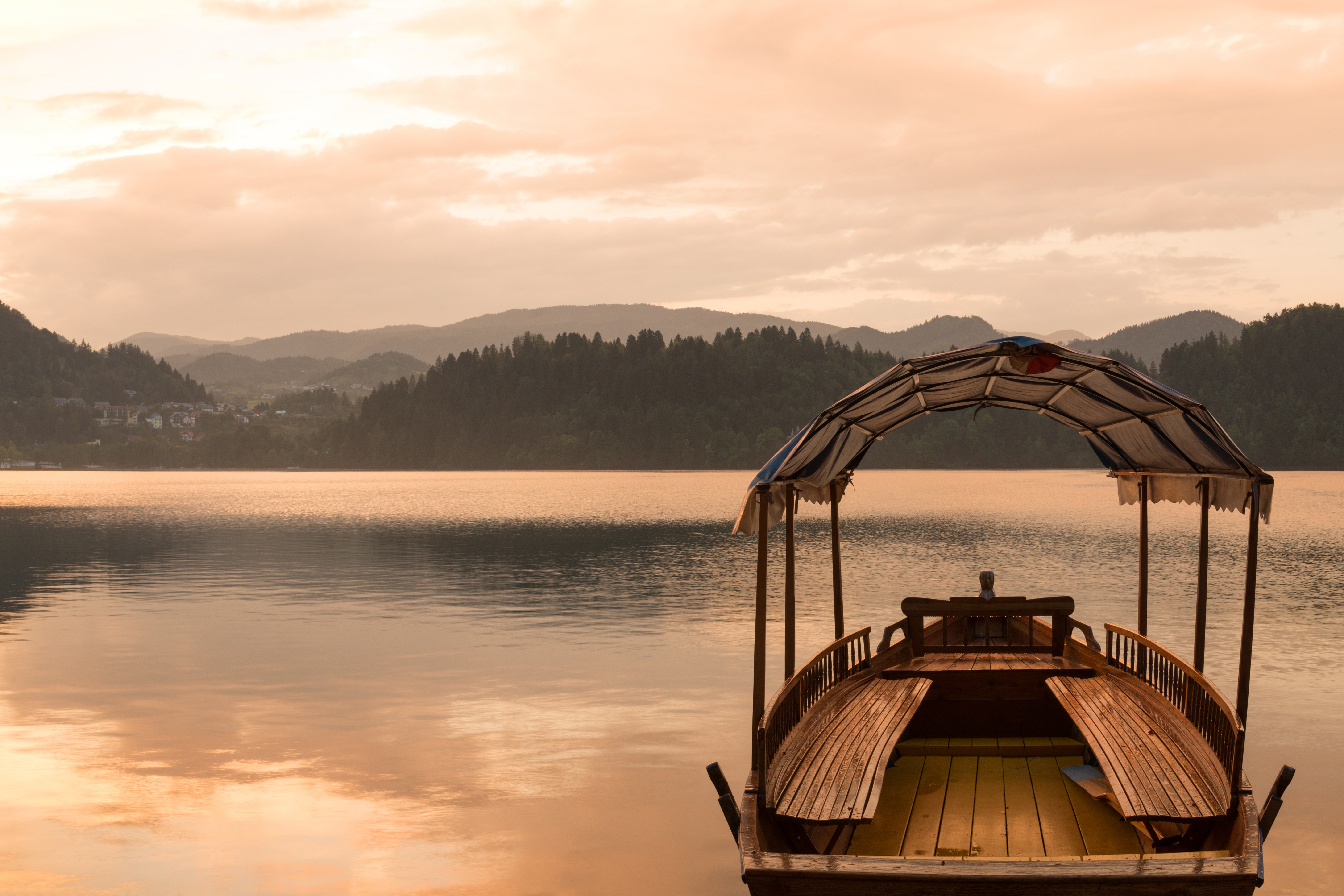 Boat on a lake with mountains in the background HD Wallpaper