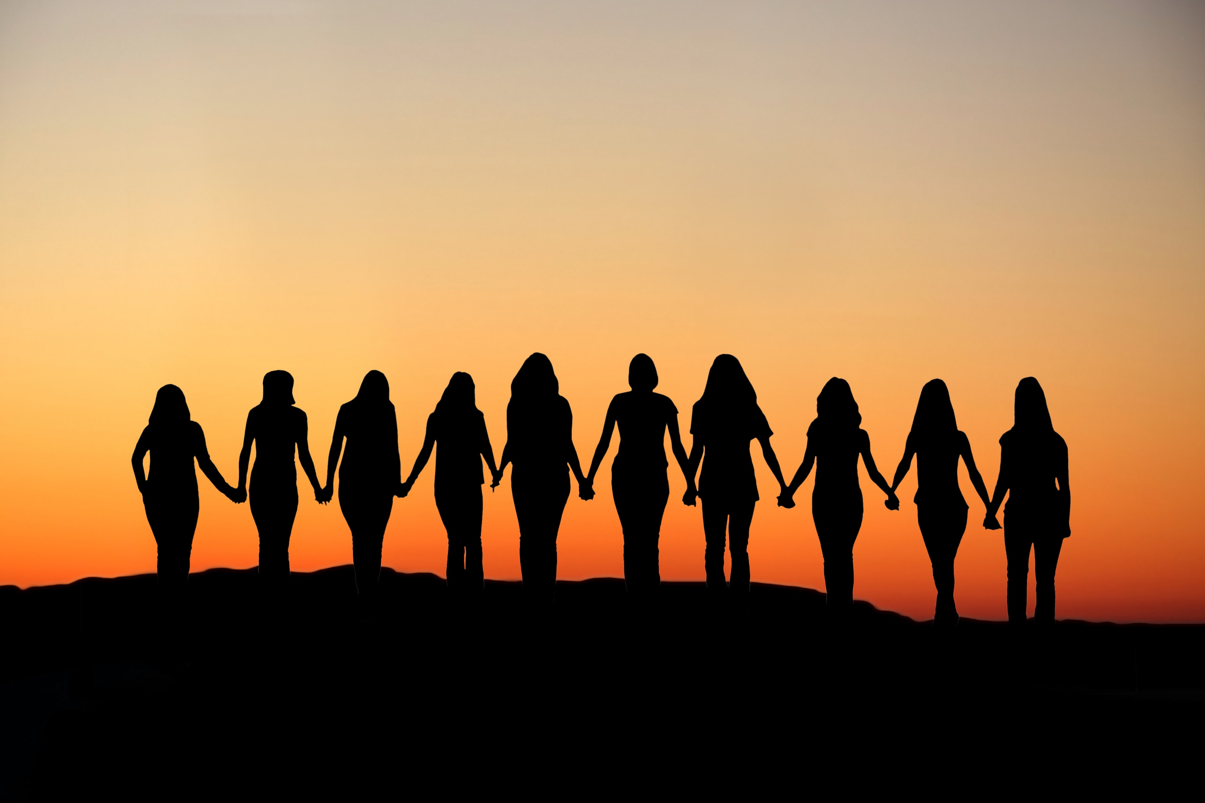 Group of women holding hands at sunset HD Wallpaper