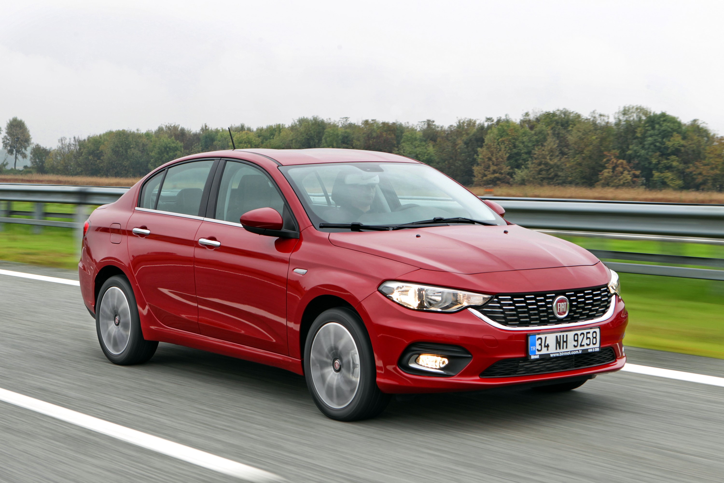 Red 2015 Fiat Tipo Sedan on a Highway HD Wallpaper