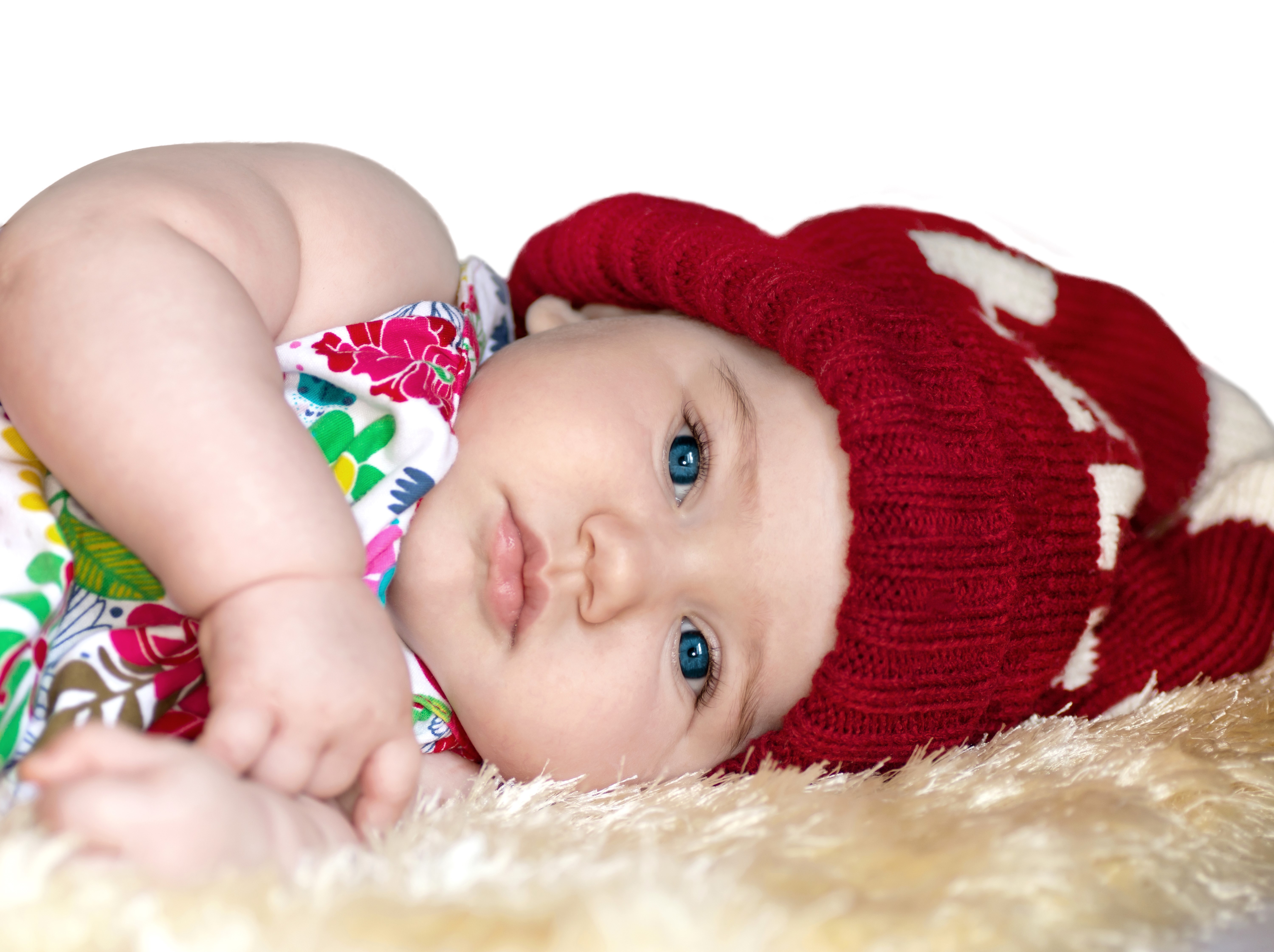 Baby wearing a red winter hat HD Wallpaper