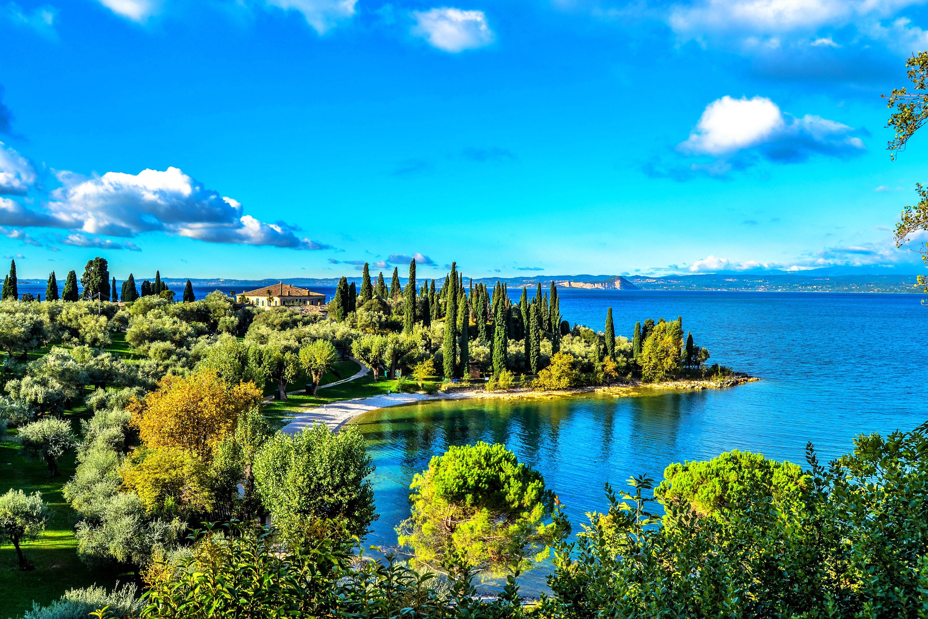 Lake Garda with cypress trees and a villa HD Wallpaper