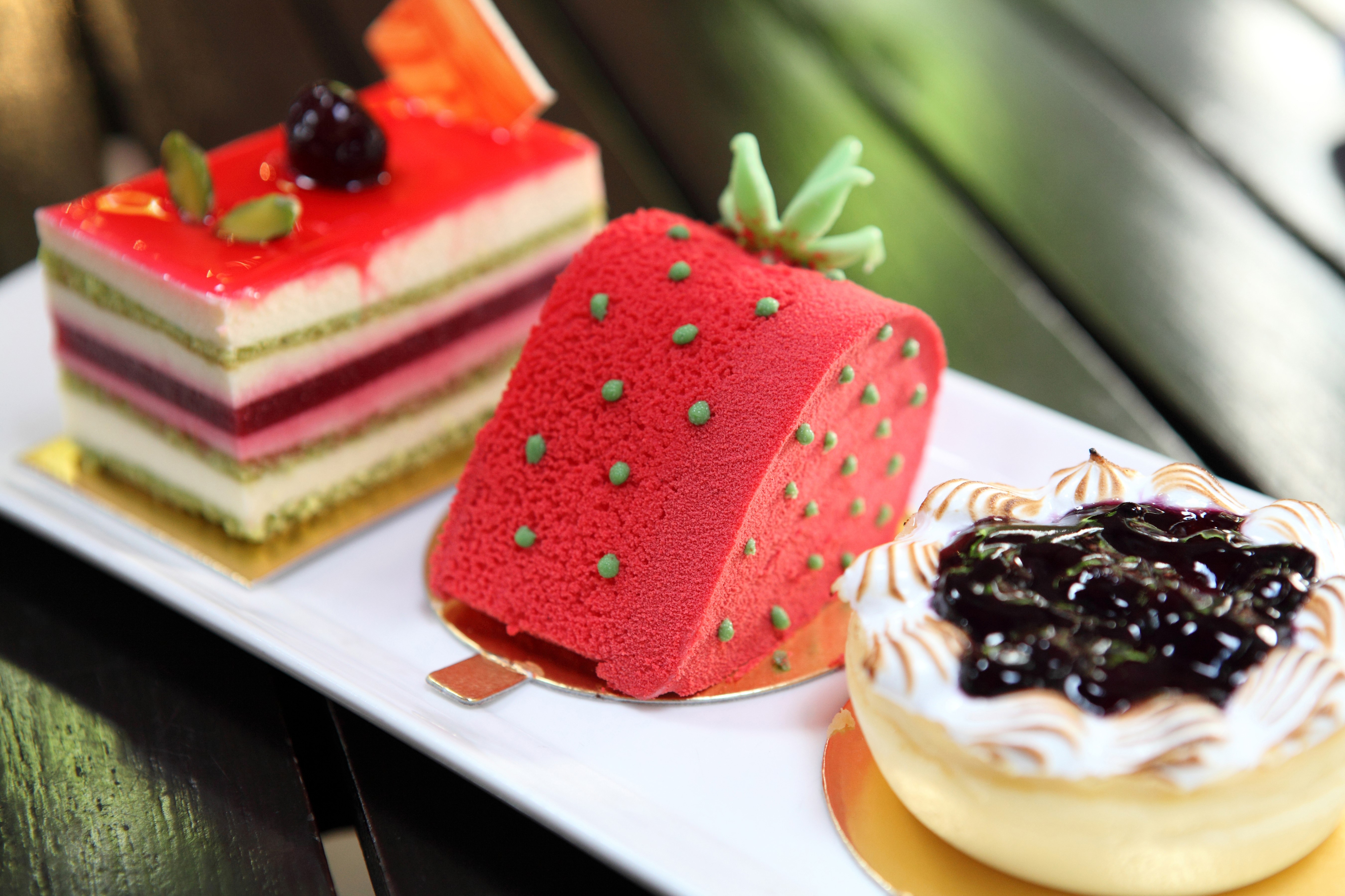 Three small cakes on a white plate HD Wallpaper