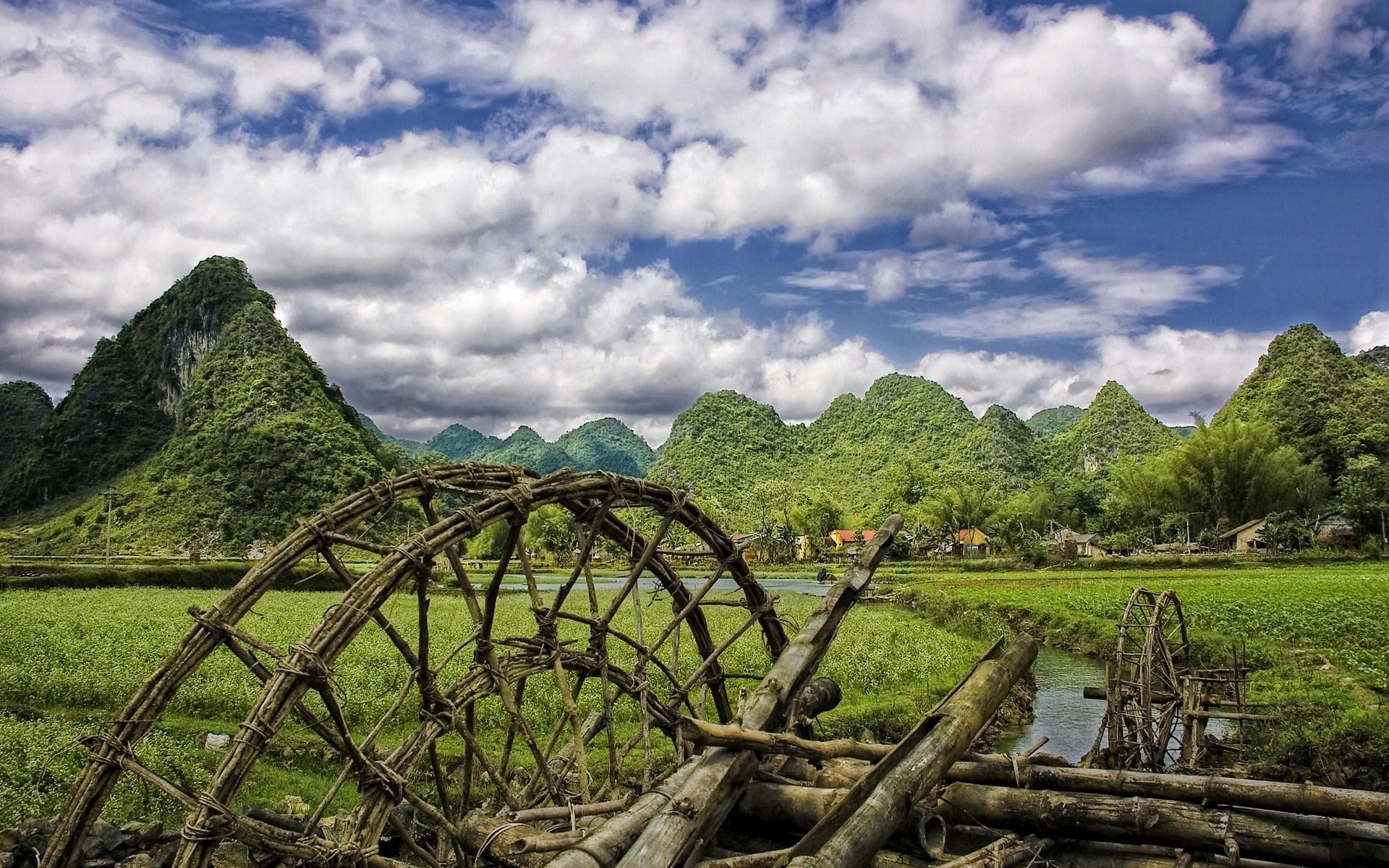 Water wheels in a rural landscape with karst mountains HD Wallpaper