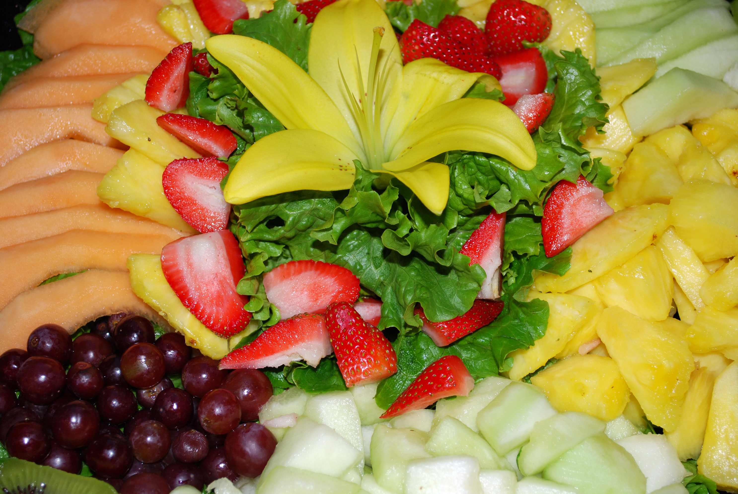 Fruit platter with strawberries, grapes, melon, and pineapple HD Wallpaper