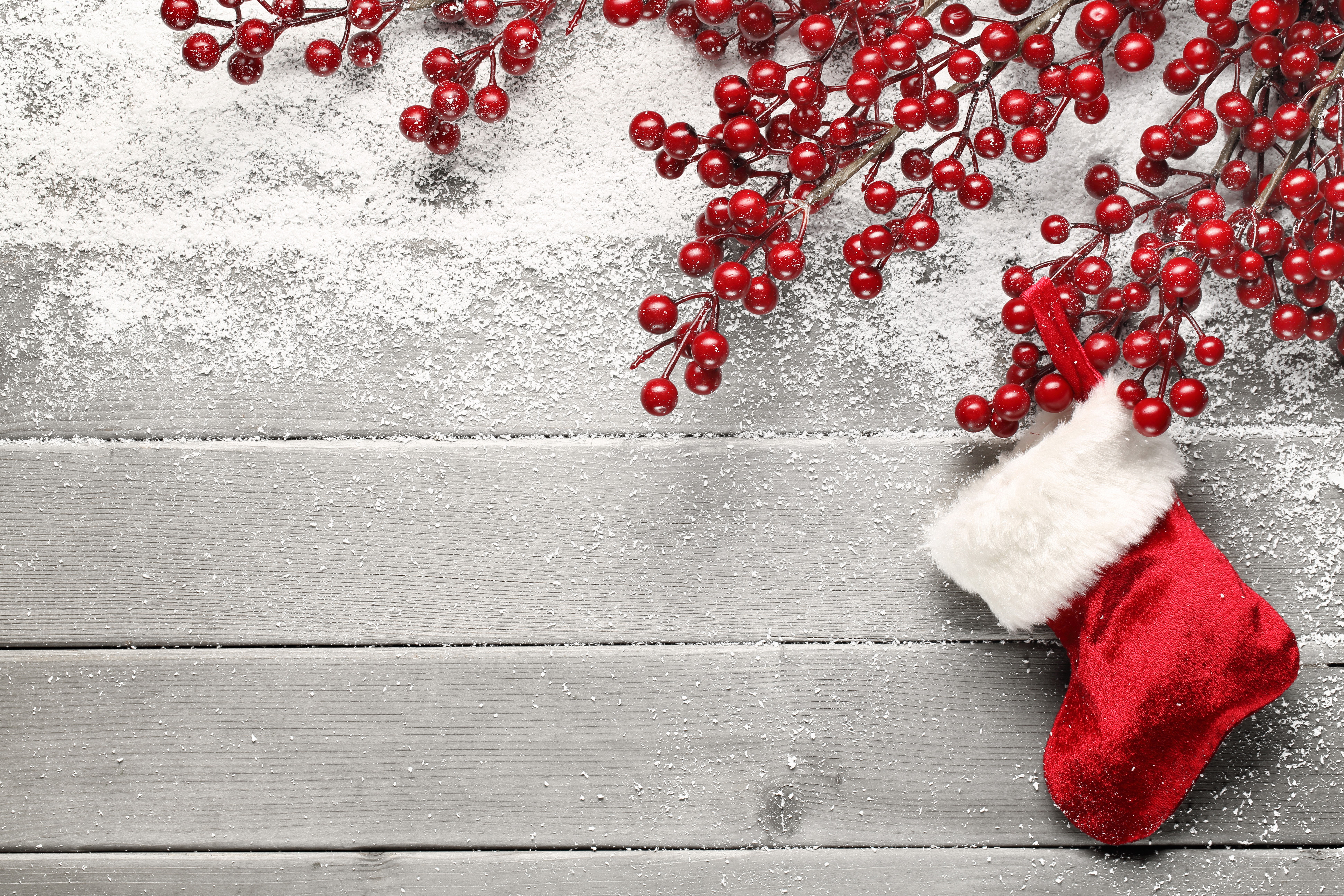 Christmas stocking with berries and snow on wood planks HD Wallpaper