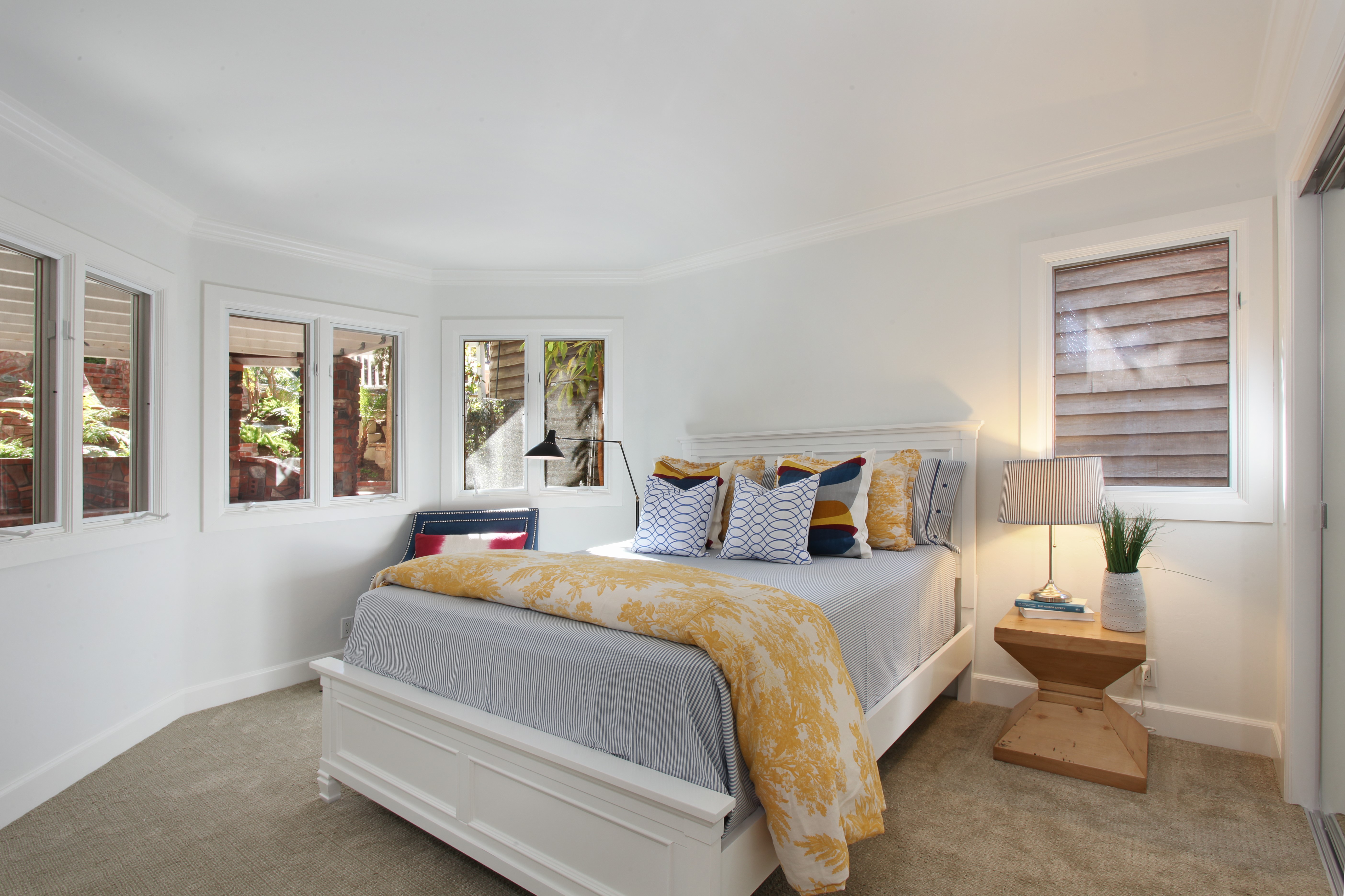 Bedroom with white bed and yellow blanket HD Wallpaper
