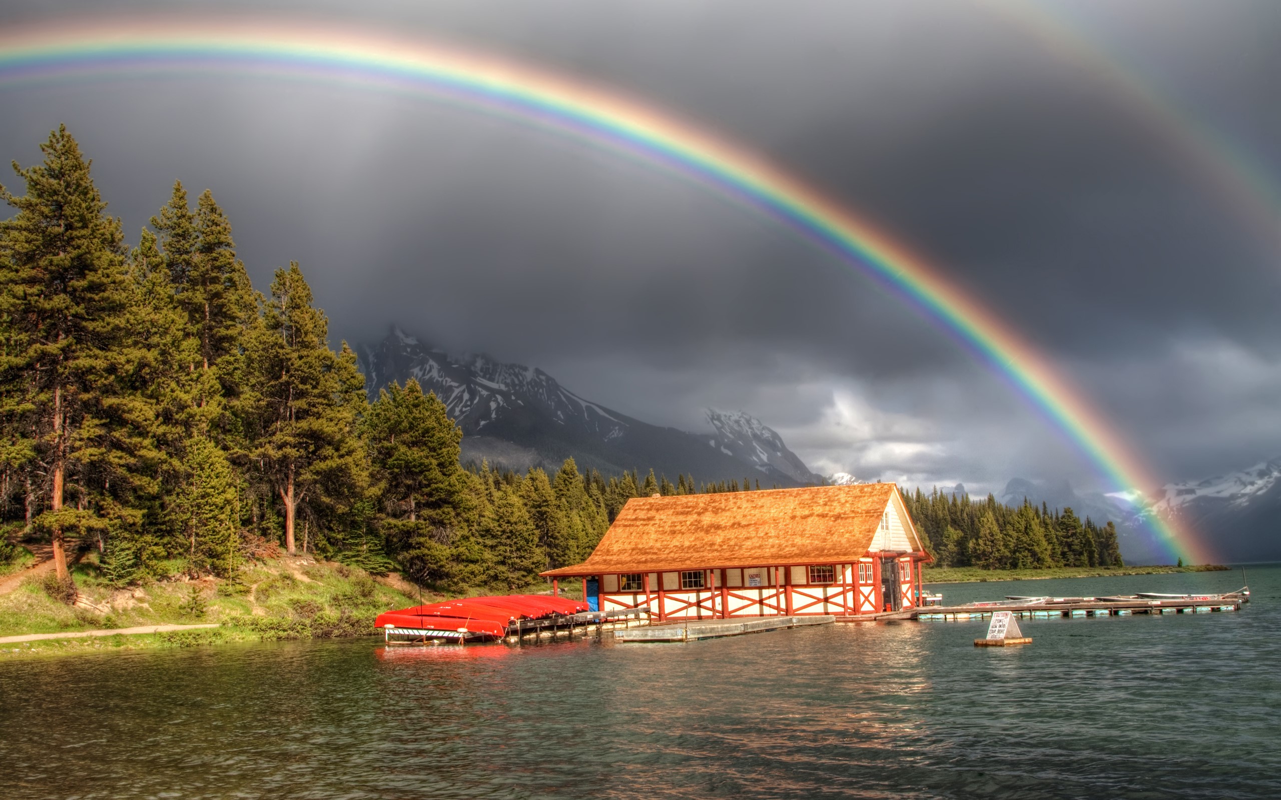 Boathouse on a lake with a double rainbow HD Wallpaper