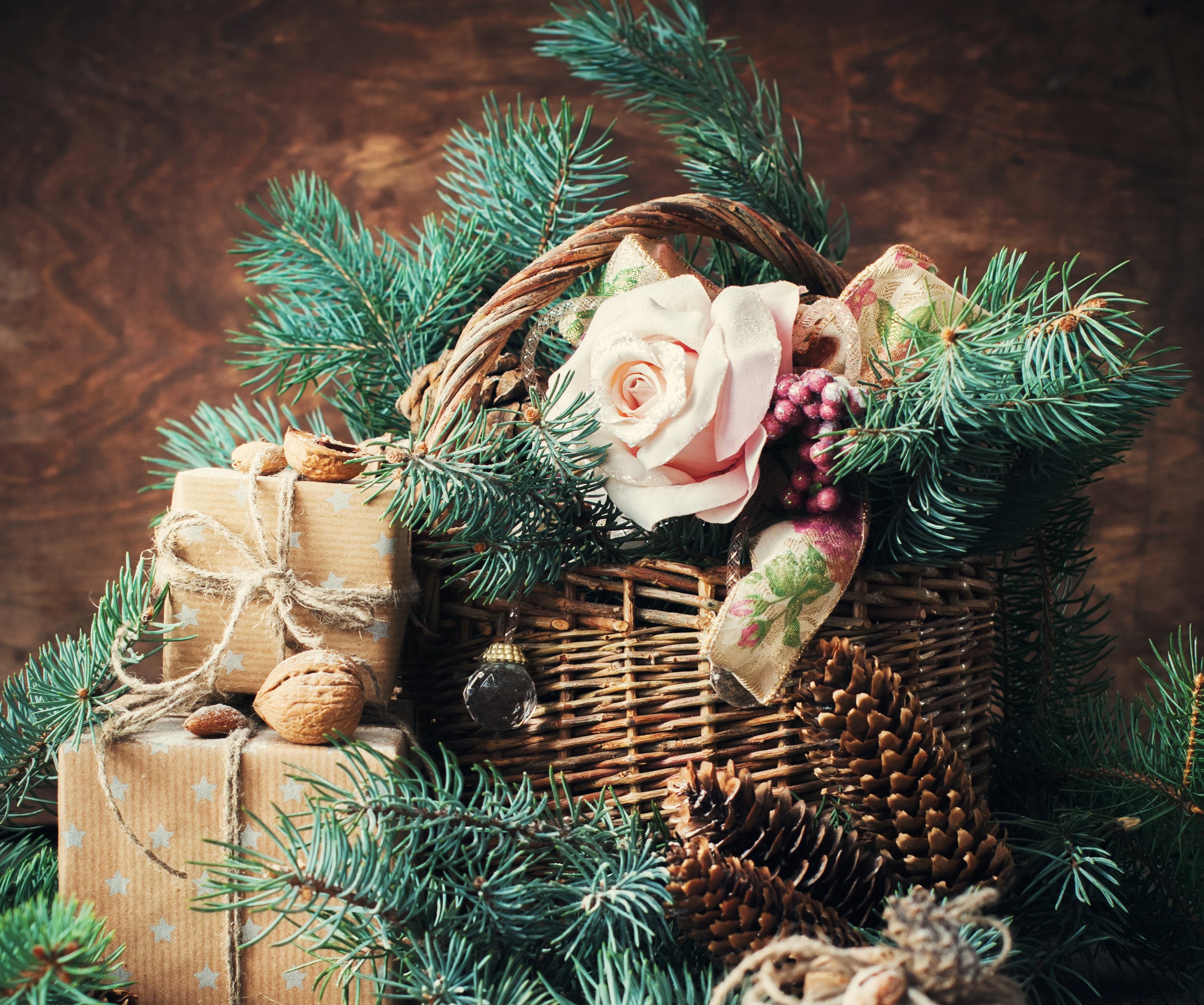 Christmas basket with gifts, roses, and pine branches HD Wallpaper