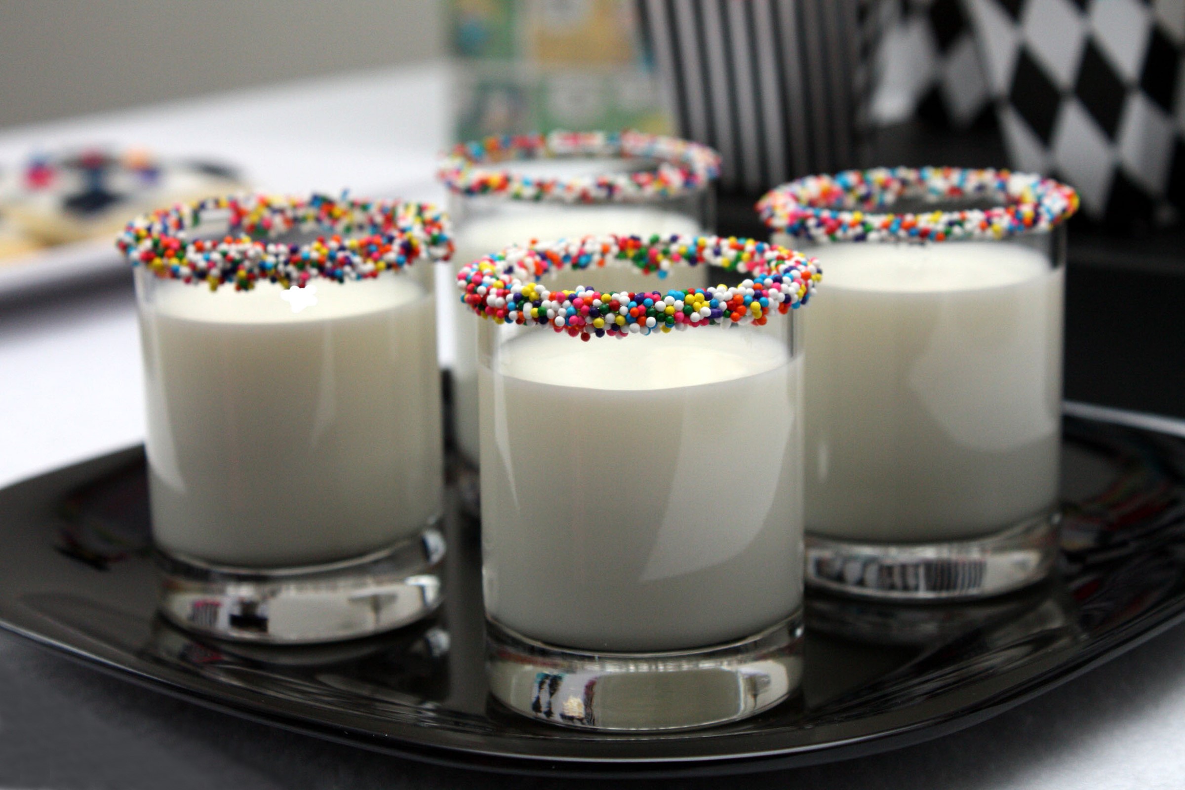 Four glasses of milk with sprinkles on a black tray HD Wallpaper