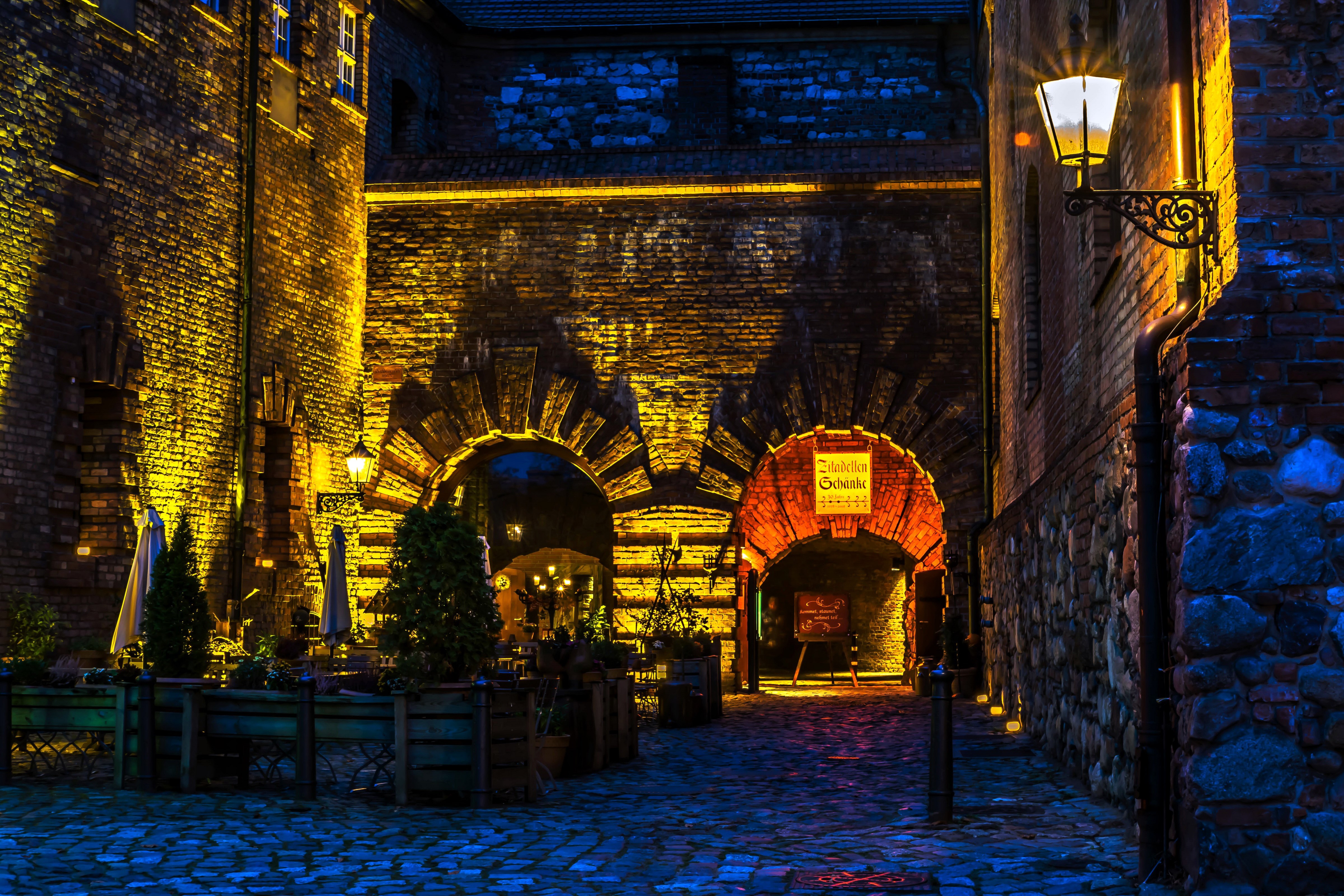 Street at night with illuminated brick arches in Berlin, Germany HD Wallpaper