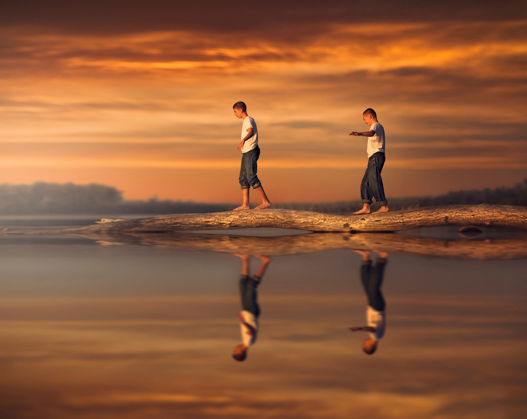 Two boys walking on a log over water at sunset HD Wallpaper
