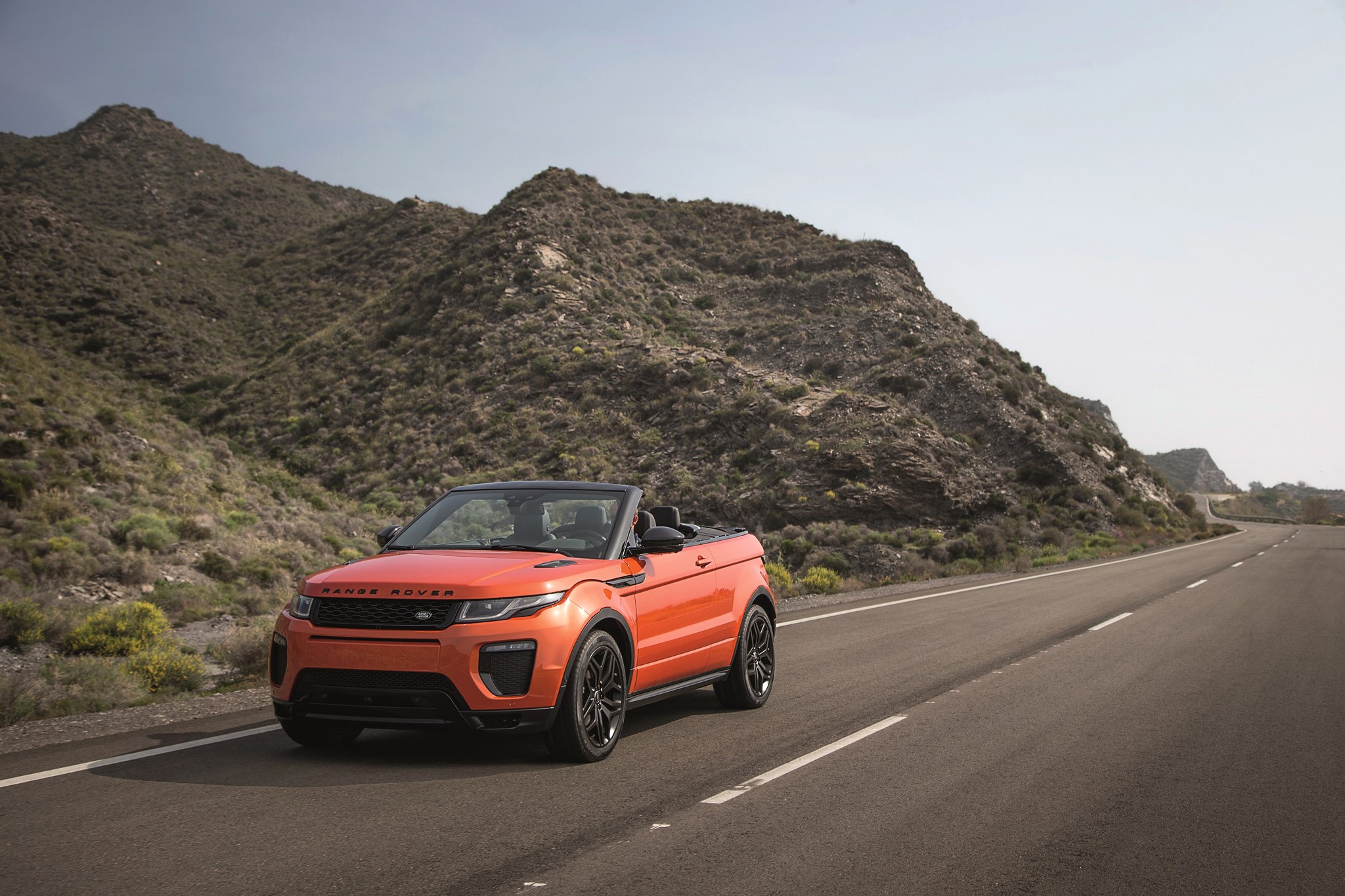 Orange Range Rover Evoque Convertible on a Mountain Road HD Wallpaper