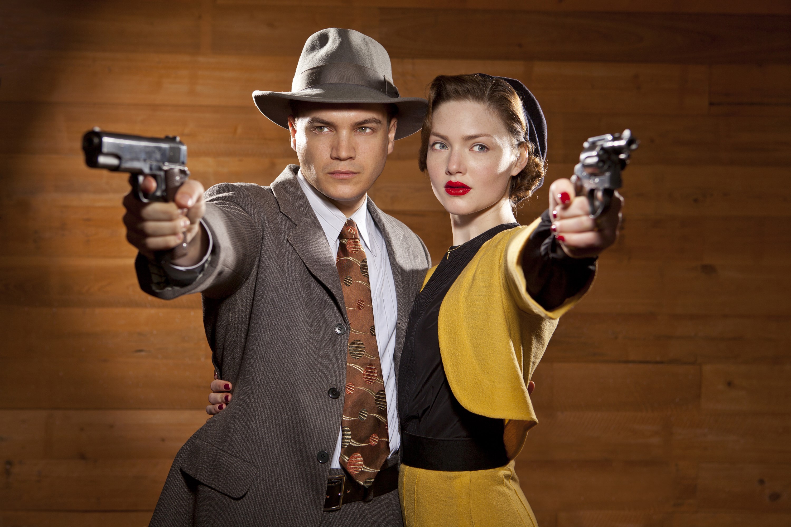 Man and woman holding pistols HD Wallpaper