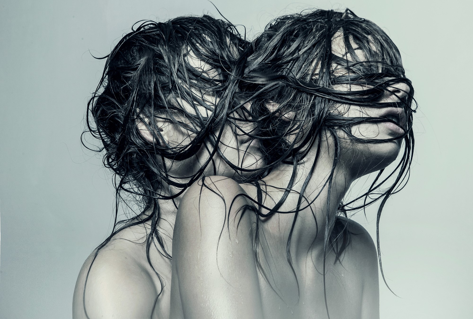 Two women with wet hair obscuring faces HD Wallpaper