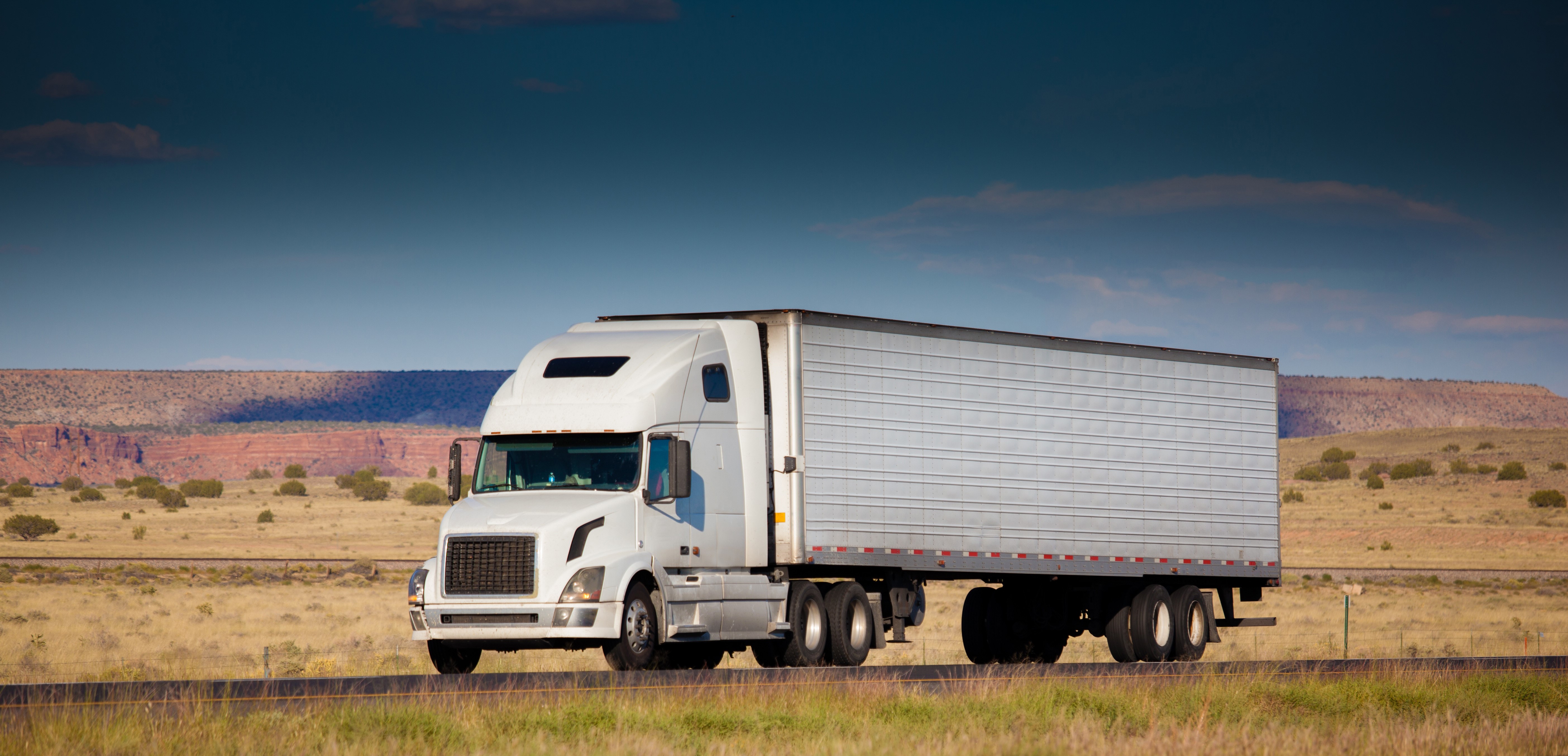 White Semi-Truck Driving on a Highway HD Wallpaper