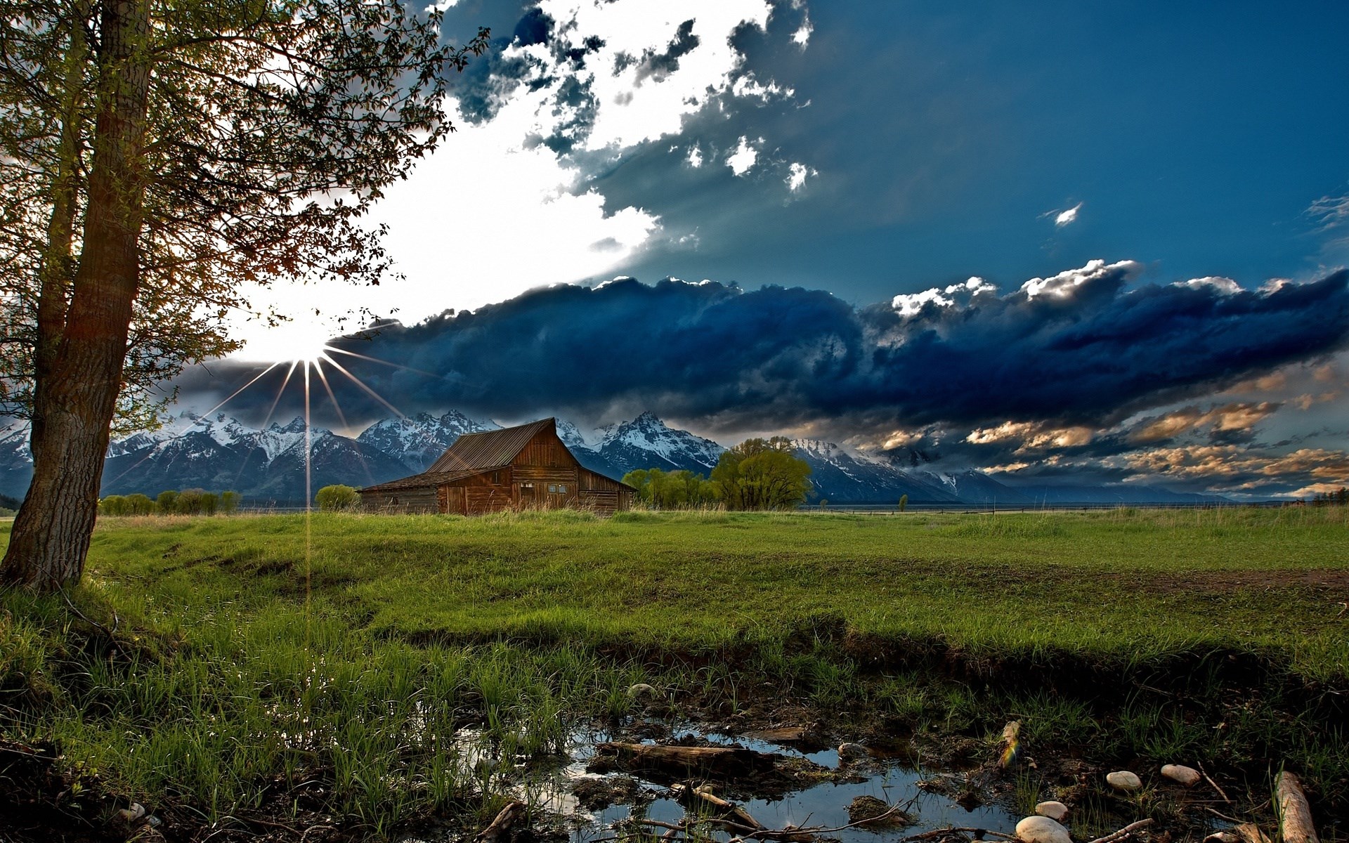 Barn and mountains under dramatic sky HD Wallpaper