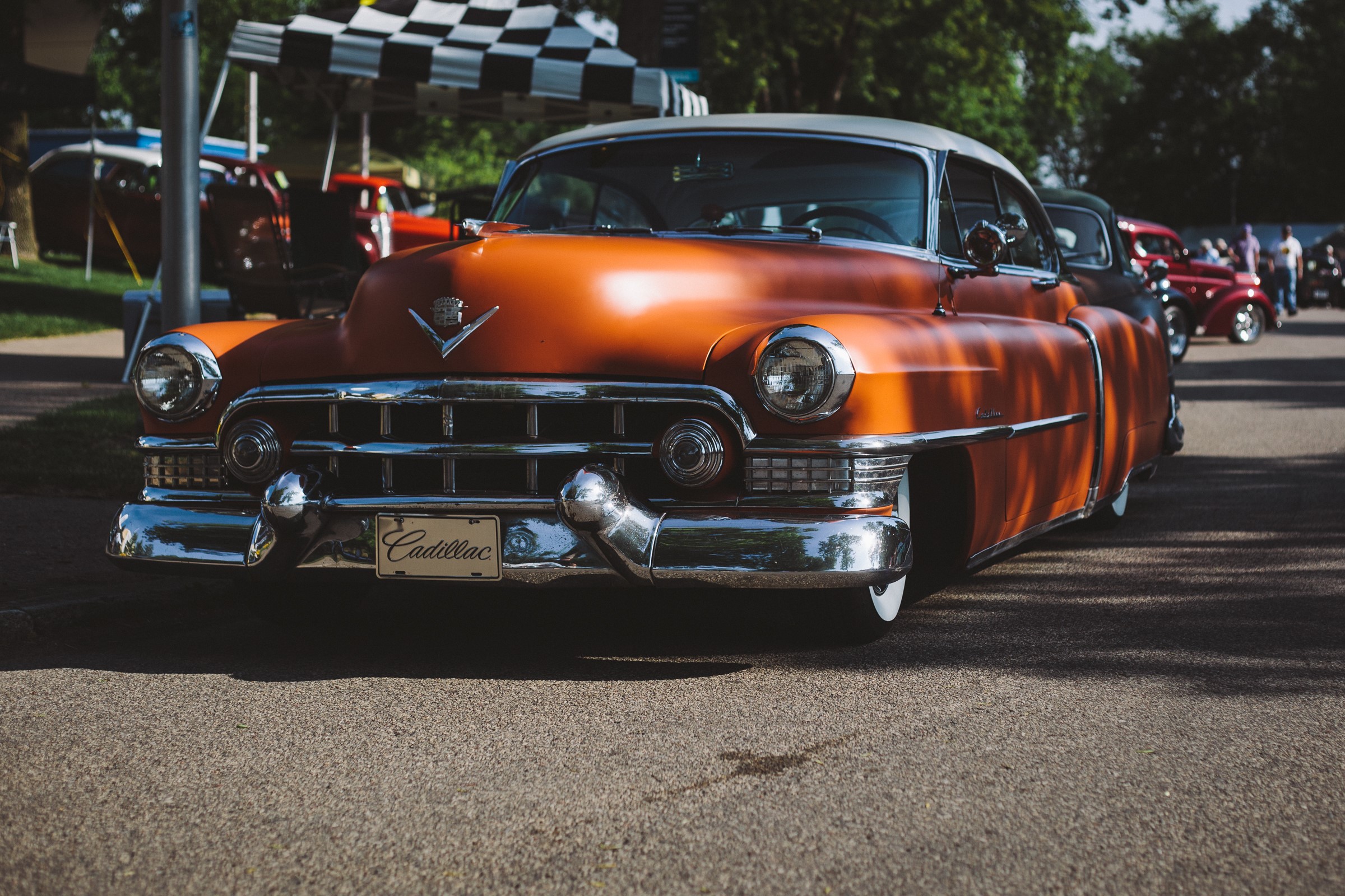 Orange Cadillac Series 62 at a car show HD Wallpaper