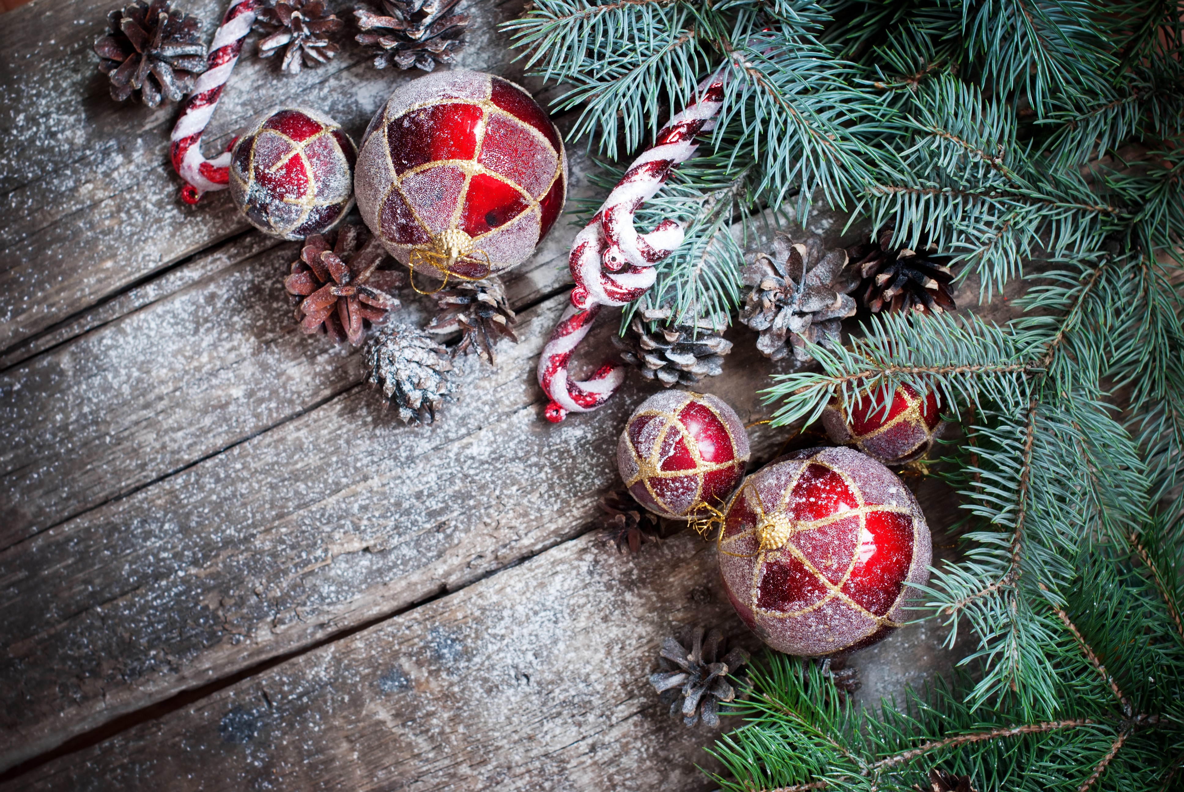Christmas ornaments and pine cones on wood planks HD Wallpaper
