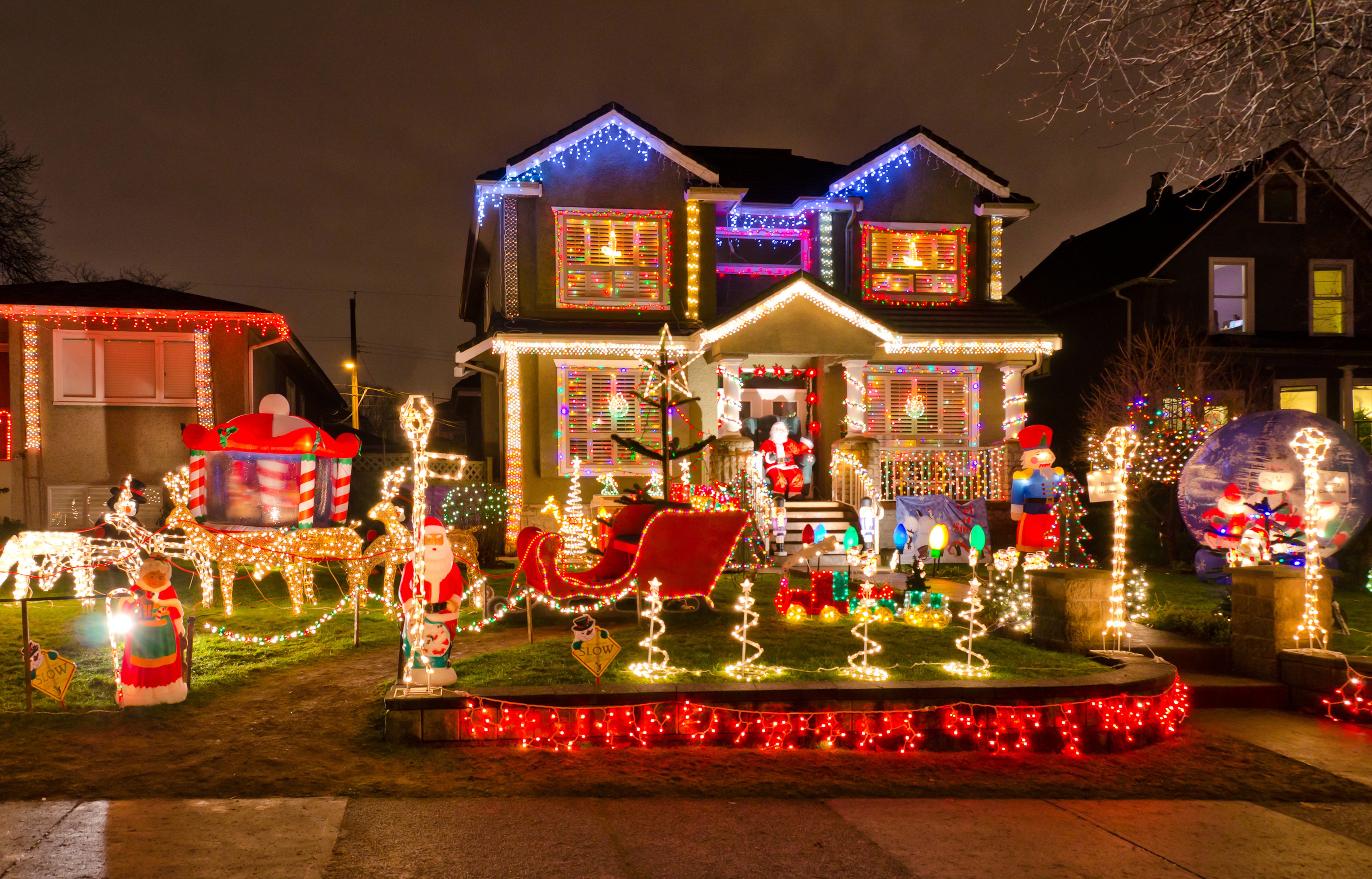 4K Christmas House Decorated with Lights and Santa Claus HD Wallpaper
