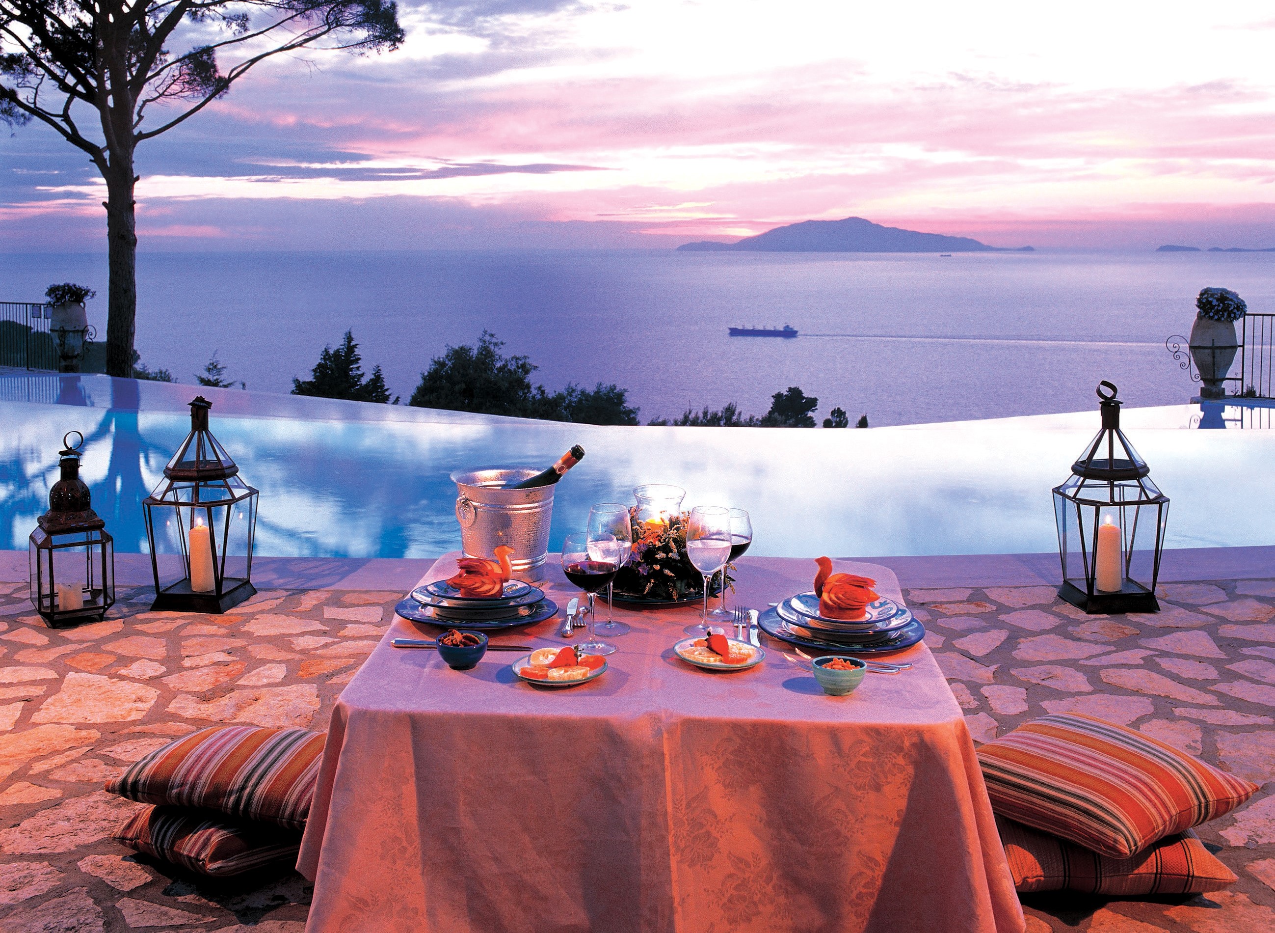 Romantic dinner by the infinity pool at sunset HD Wallpaper