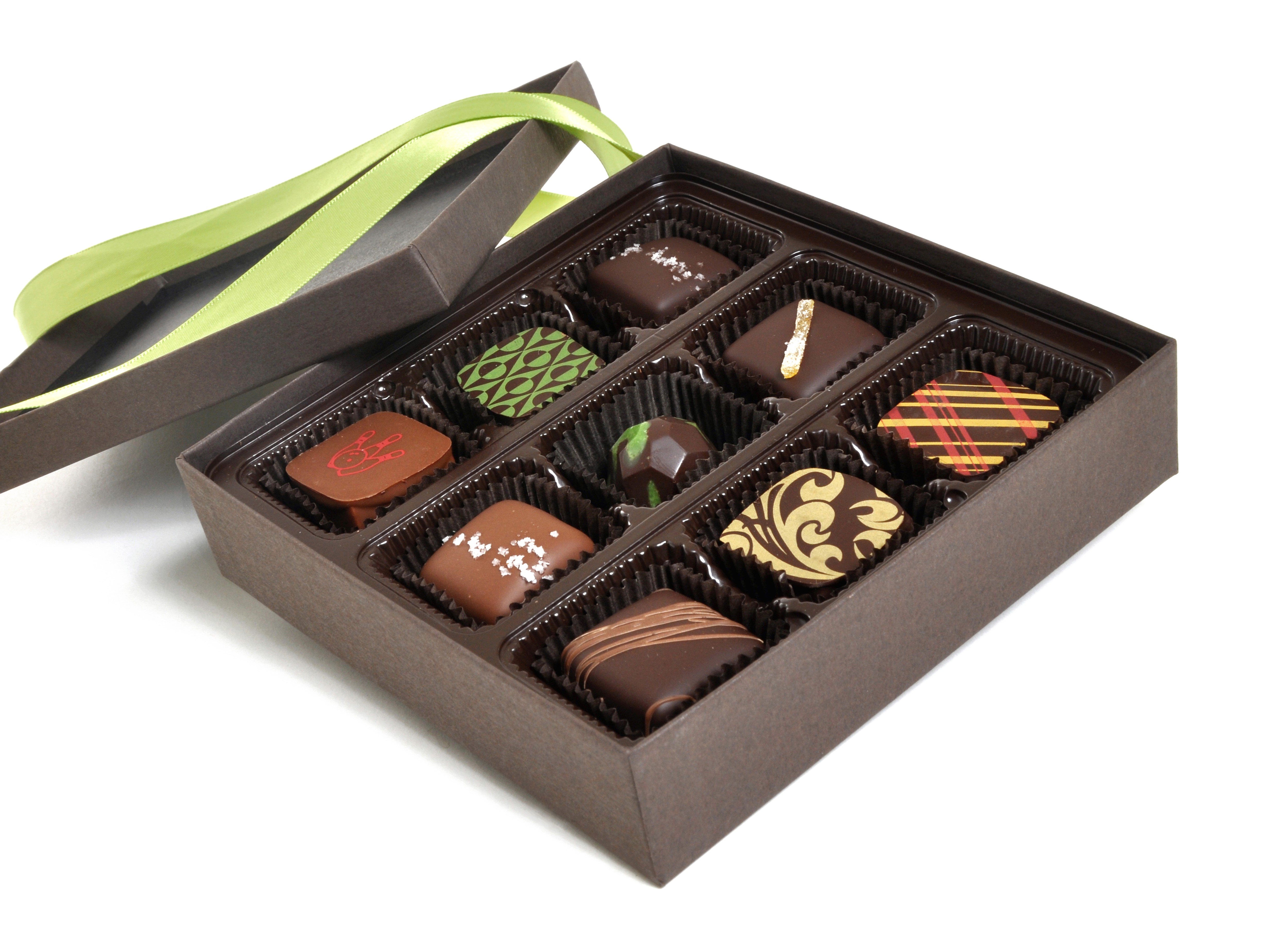 Box of assorted chocolates with green ribbon HD Wallpaper
