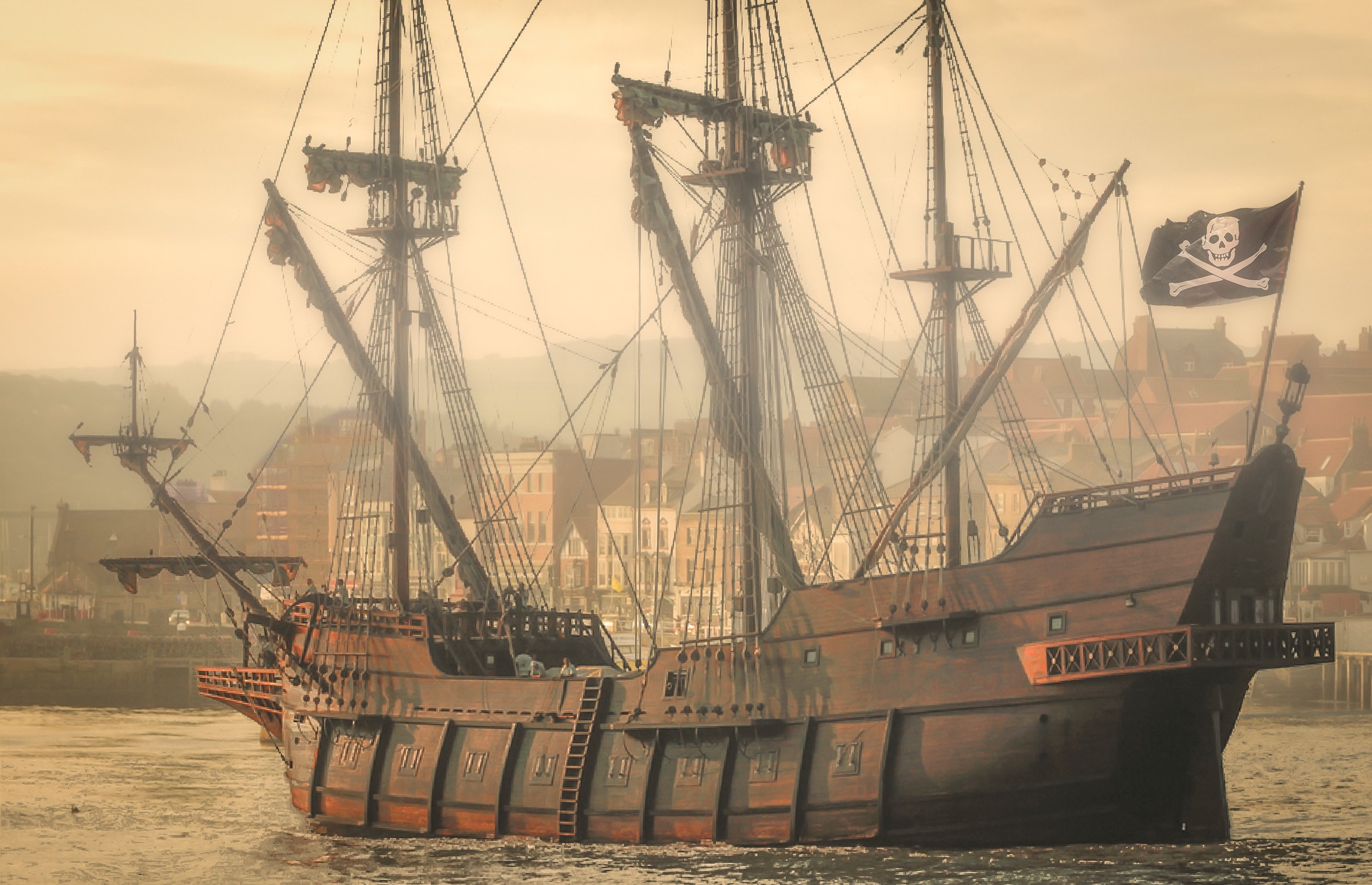 Pirate ship with Jolly Roger flag sailing HD Wallpaper