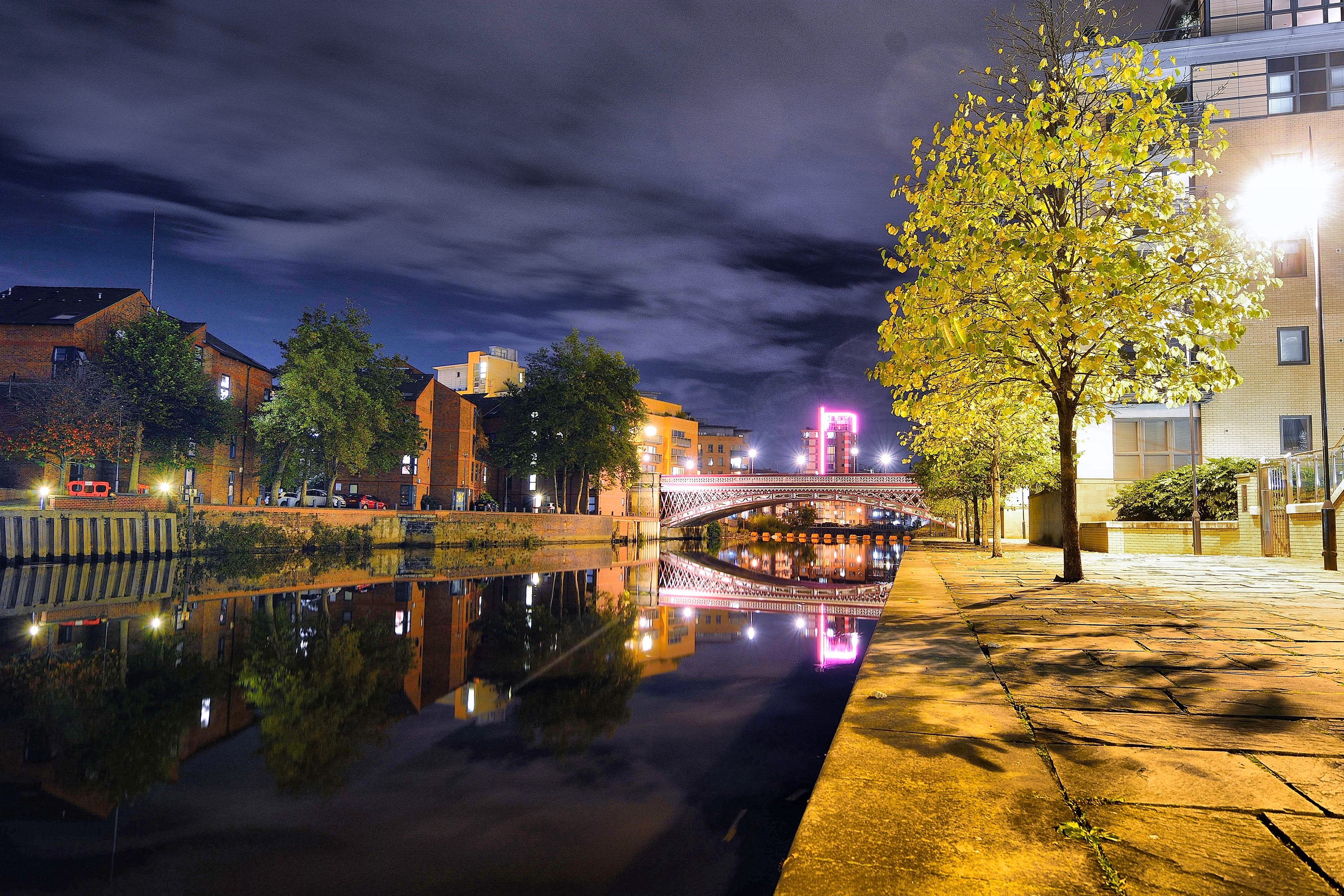 Leeds, United Kingdom at night with river and bridge HD Wallpaper