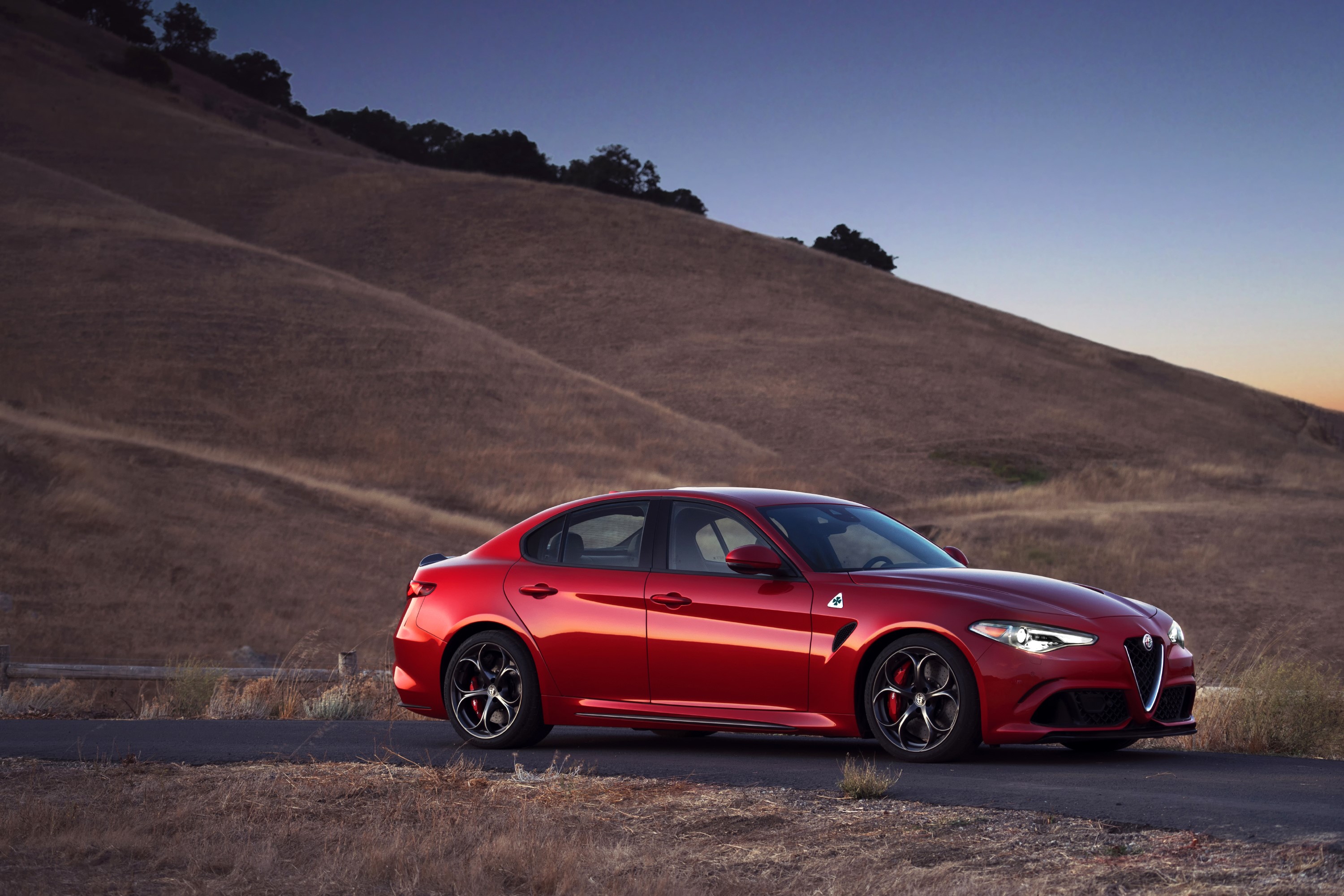 Red Alfa Romeo Giulia Quadrifoglio on a road HD Wallpaper