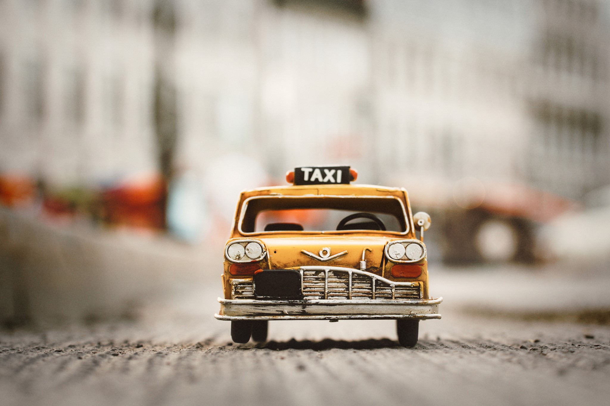 Yellow toy taxi with TAXI sign on top HD Wallpaper