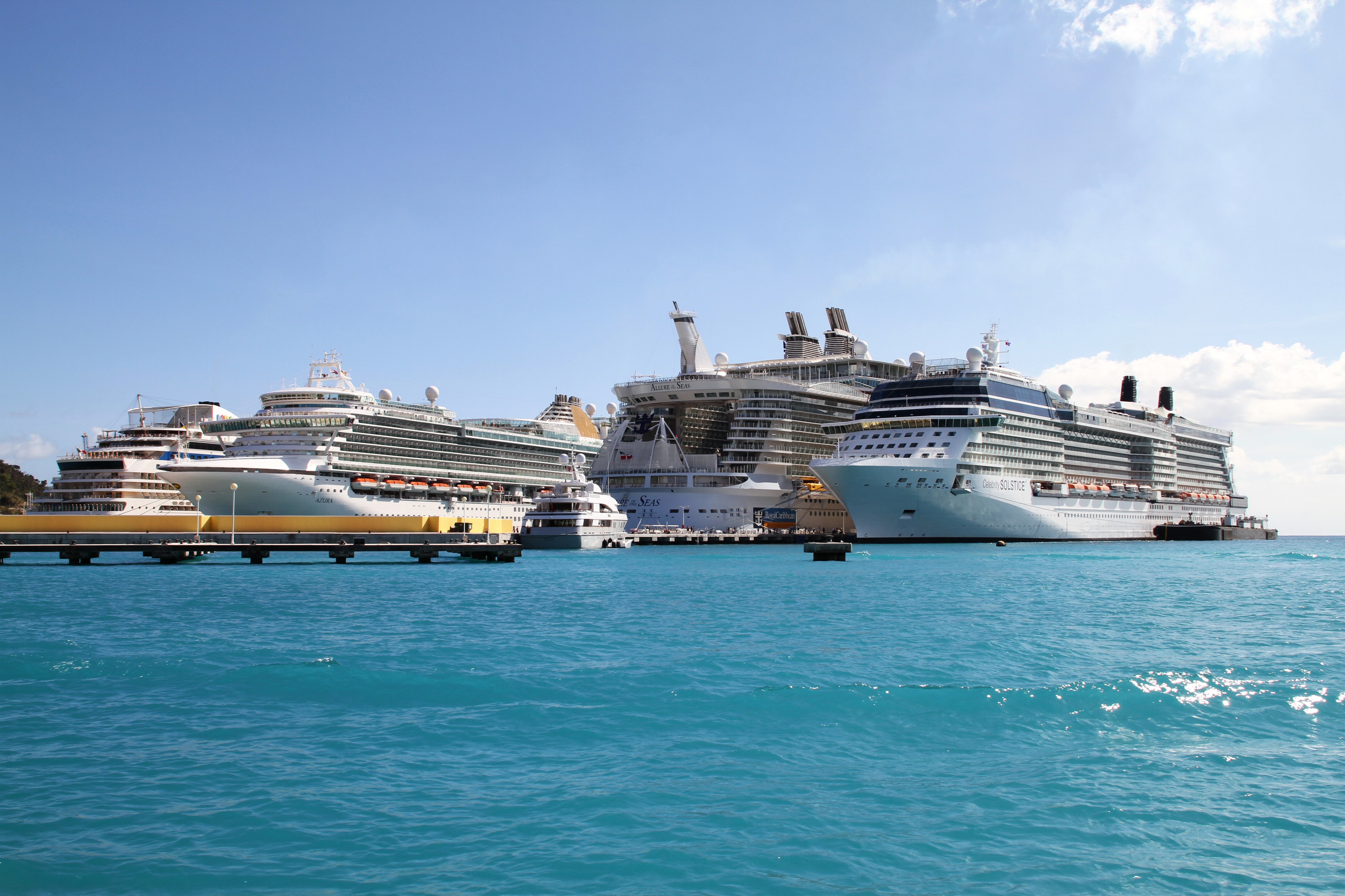 Cruise liners docked at a sunny marina HD Wallpaper