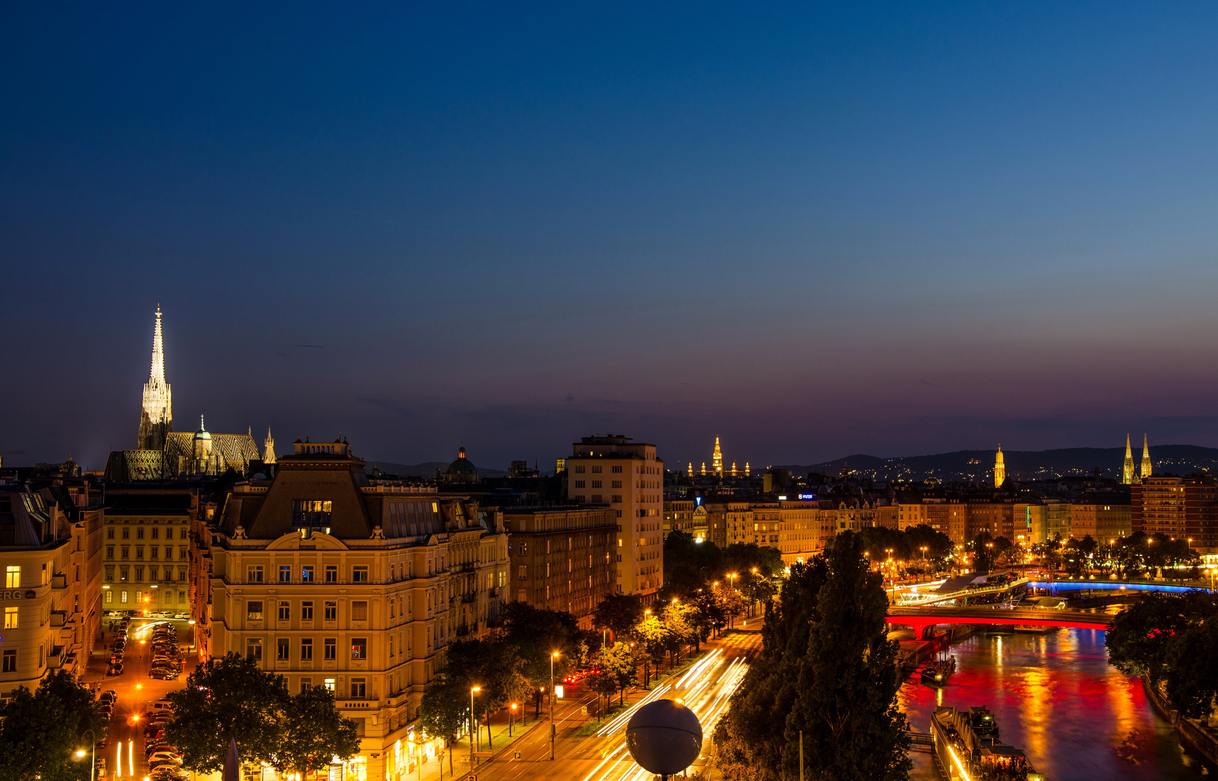 Vienna cityscape at night with St. Stephen's Cathedral and Danube Canal HD Wallpaper