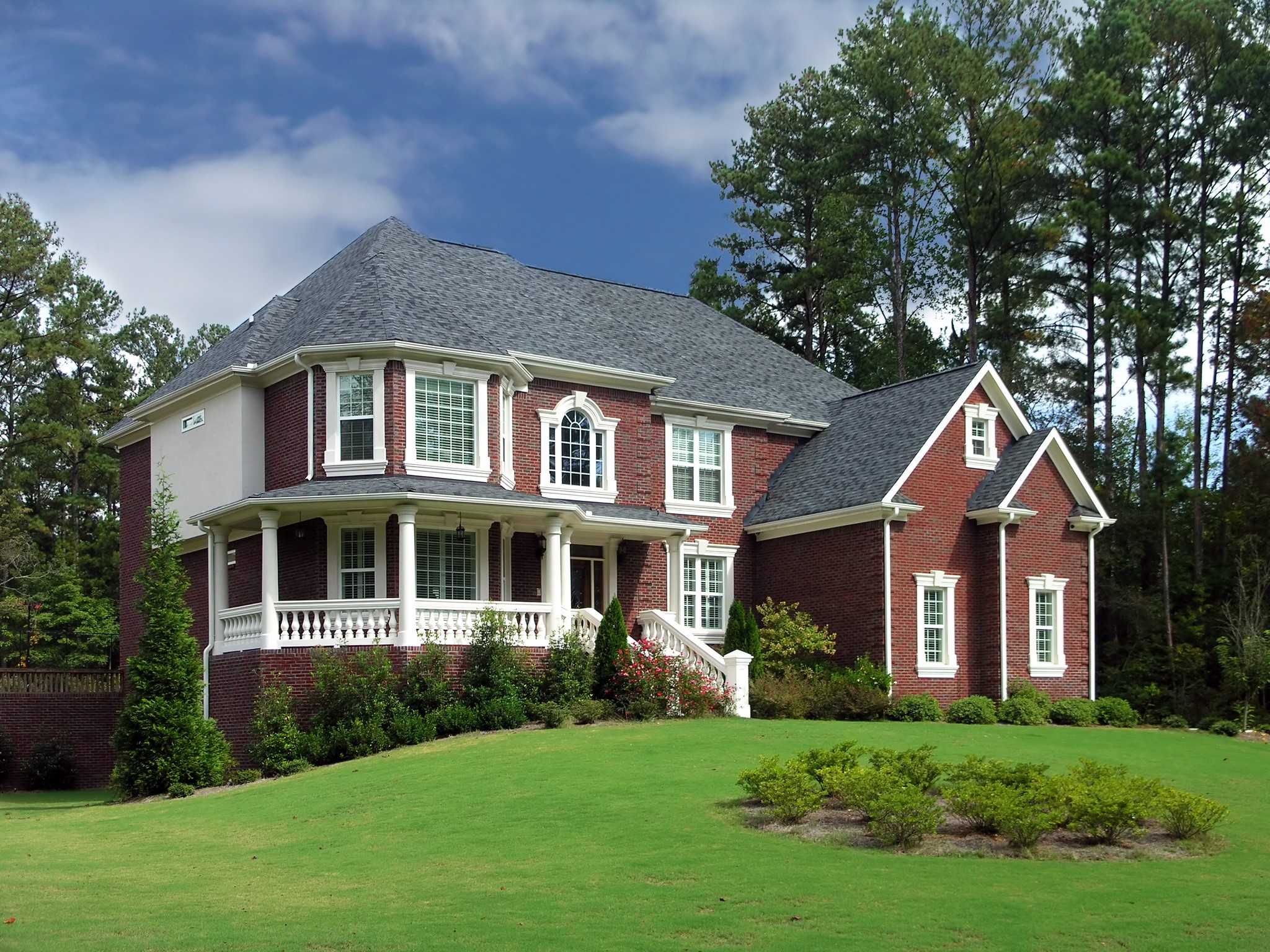 Brick Mansion with White Trim and Green Lawn HD Wallpaper