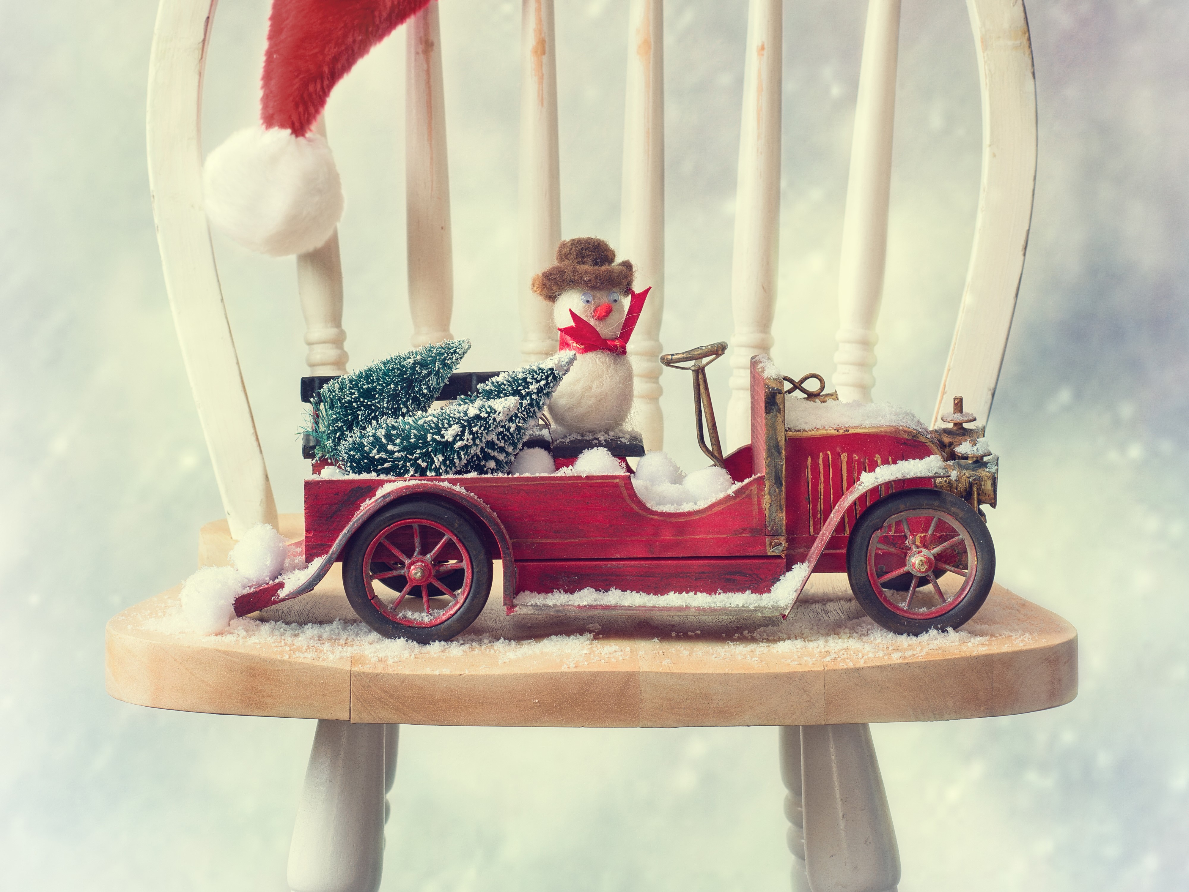 Christmas toy car with snowman and trees on chair HD Wallpaper