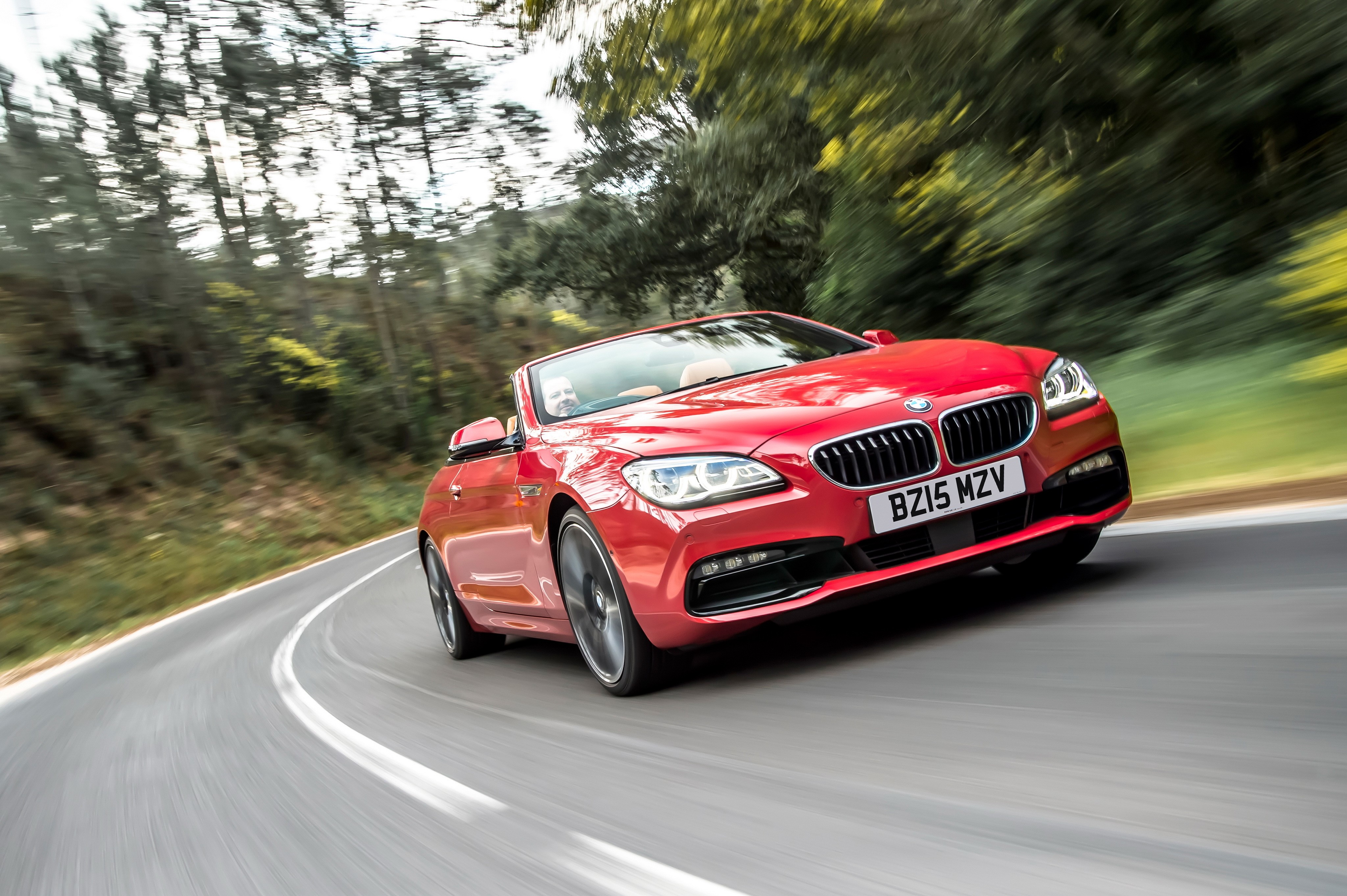 Red BMW 650i Cabriolet driving on a road HD Wallpaper