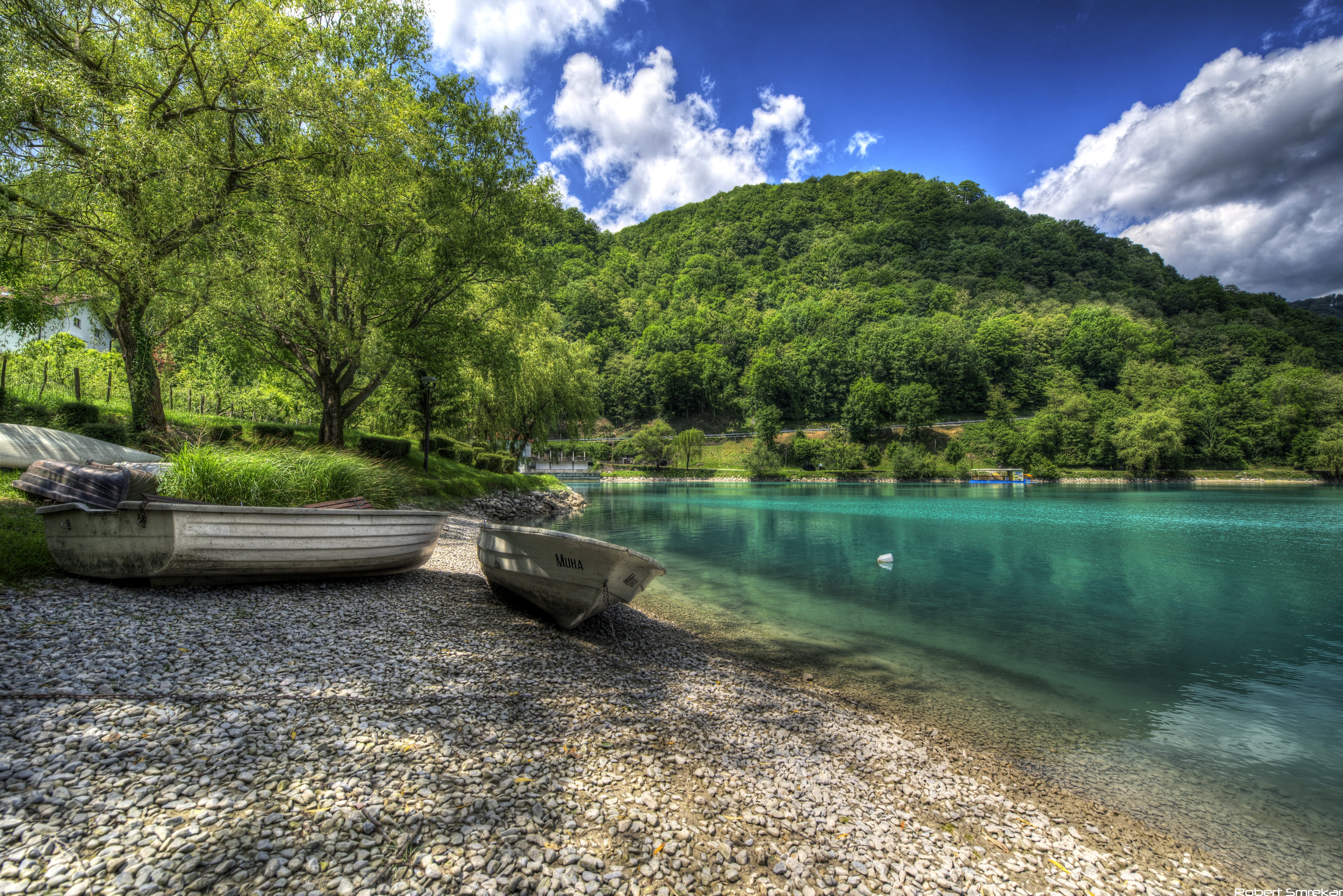 Boats on the shore of a turquoise lake in Slovenia HD Wallpaper