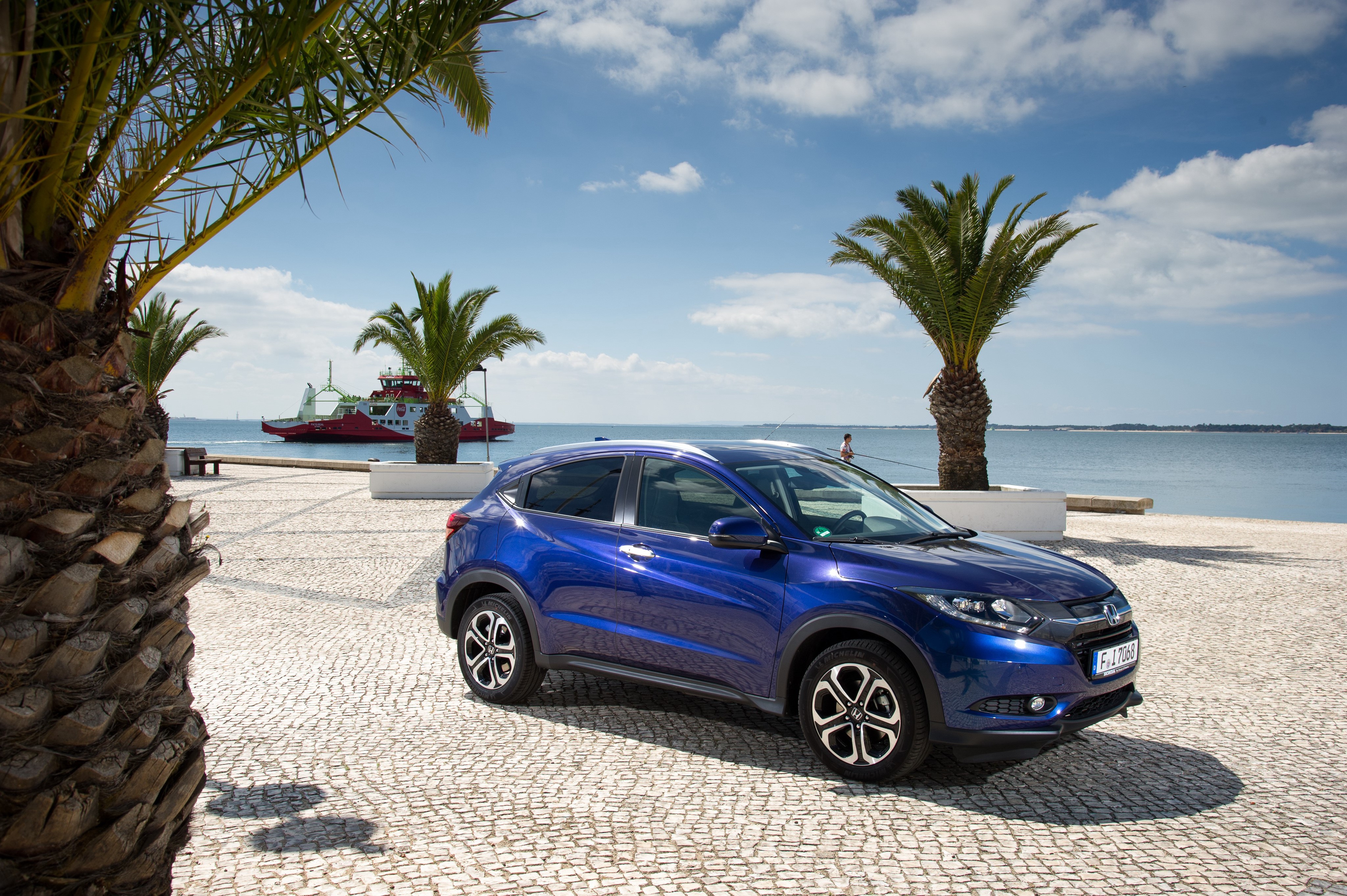 Blue Honda HR-V by the water with palm trees HD Wallpaper