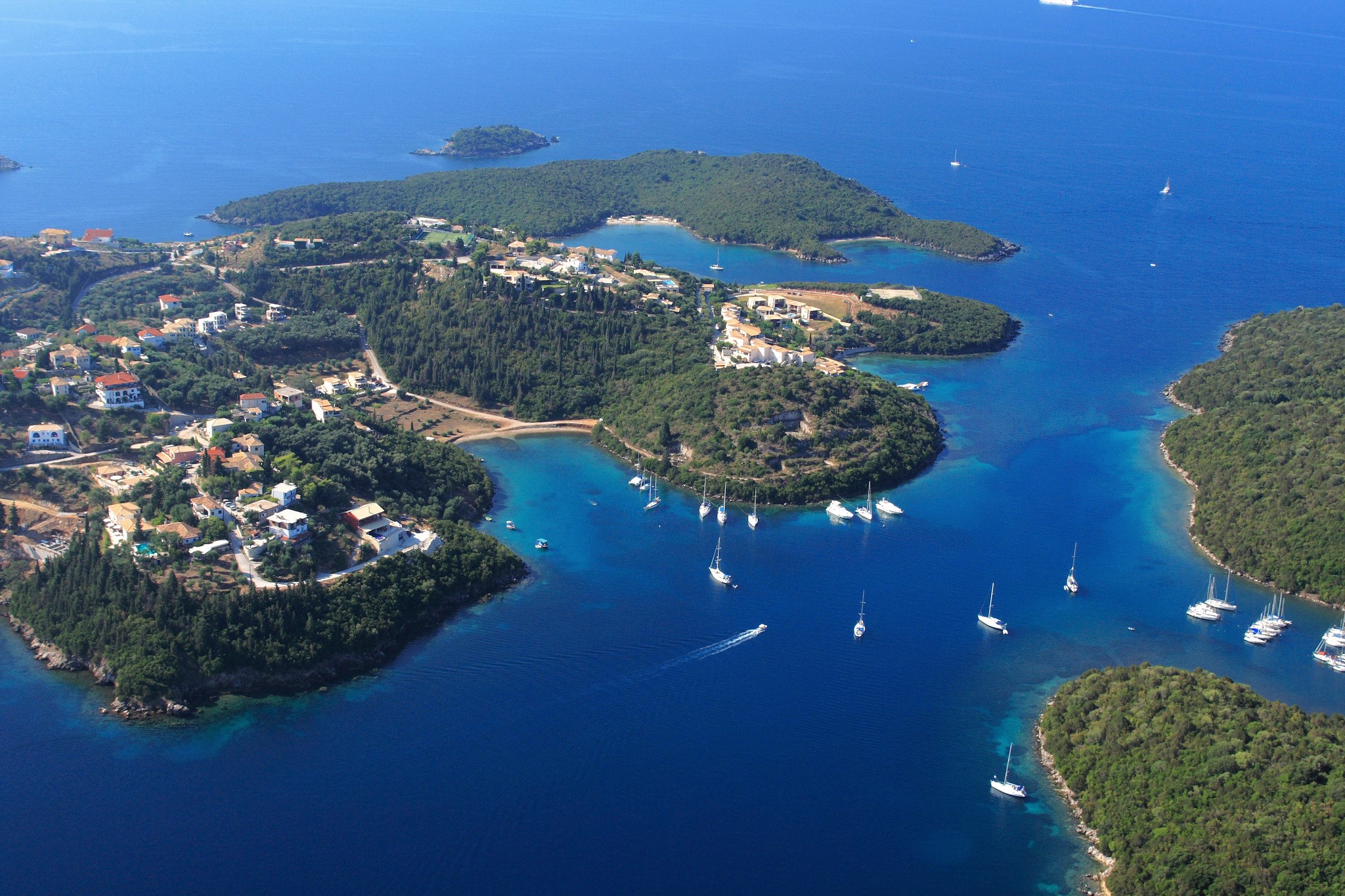 Sivota, Greece: Aerial view of coastal village and bay with sailboats HD Wallpaper